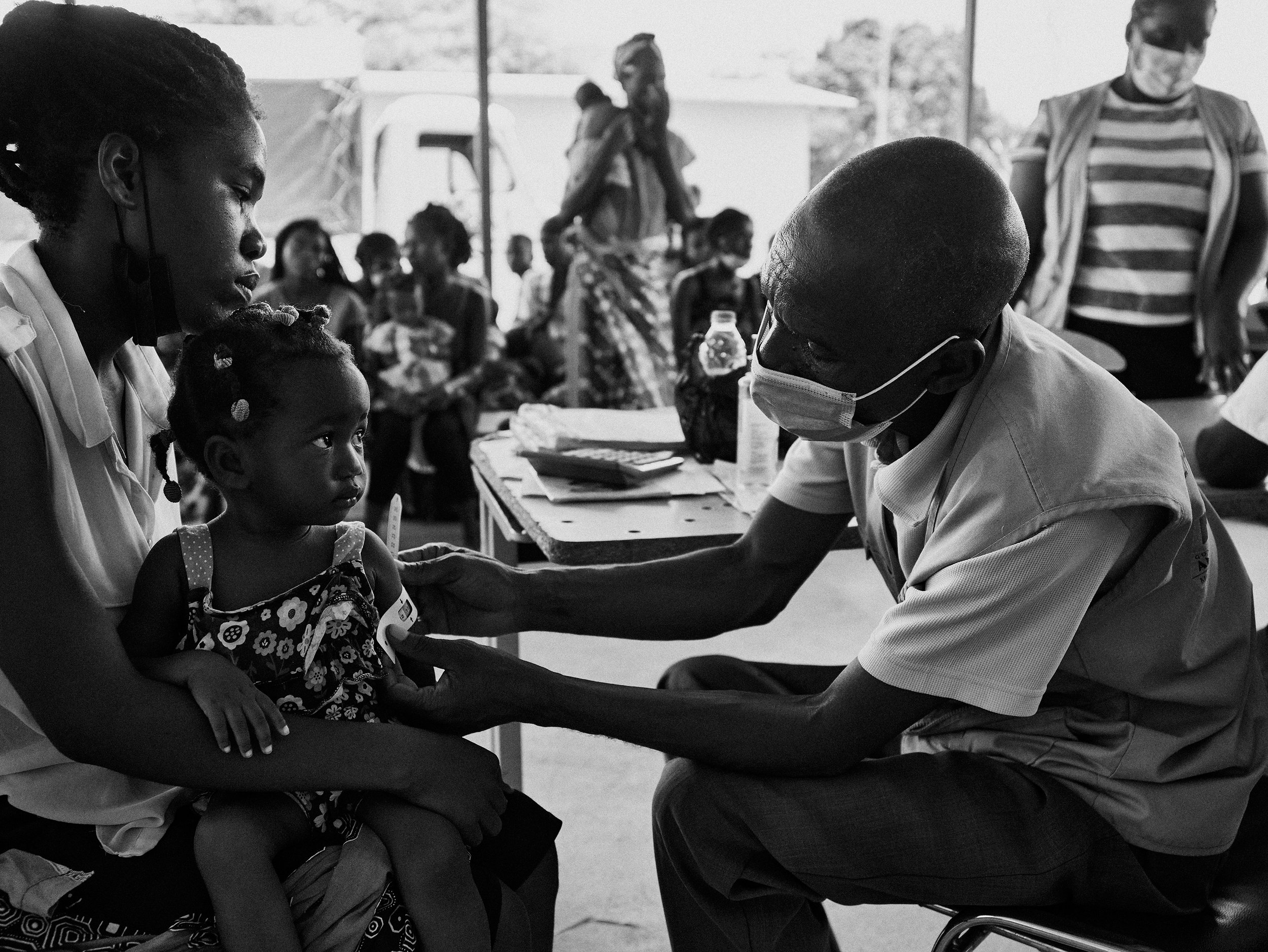 WFP clinician measuring the growth of a malnourished child, Angola