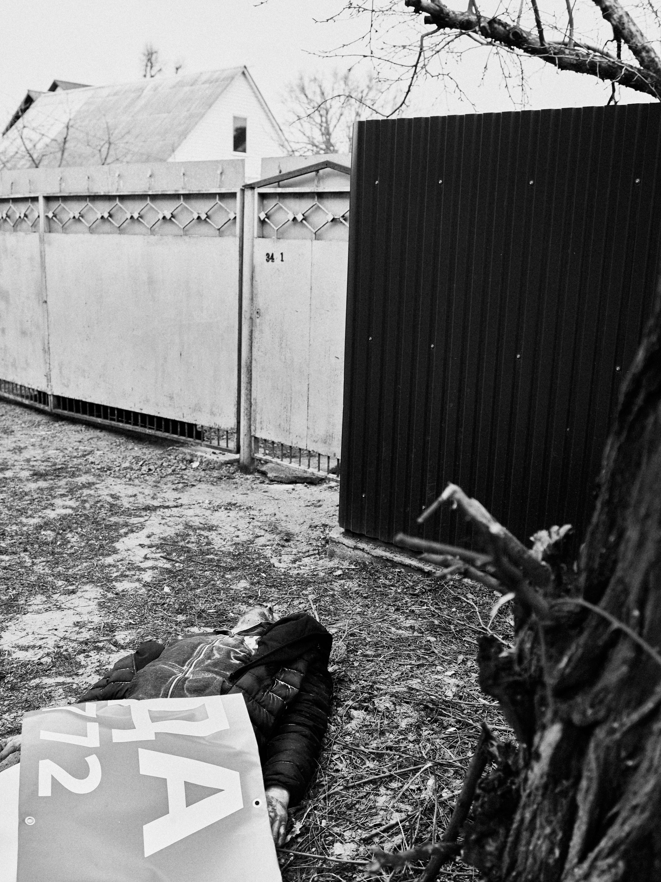 A man lies dead in front of his home in Irpin, Kyiv Oblast