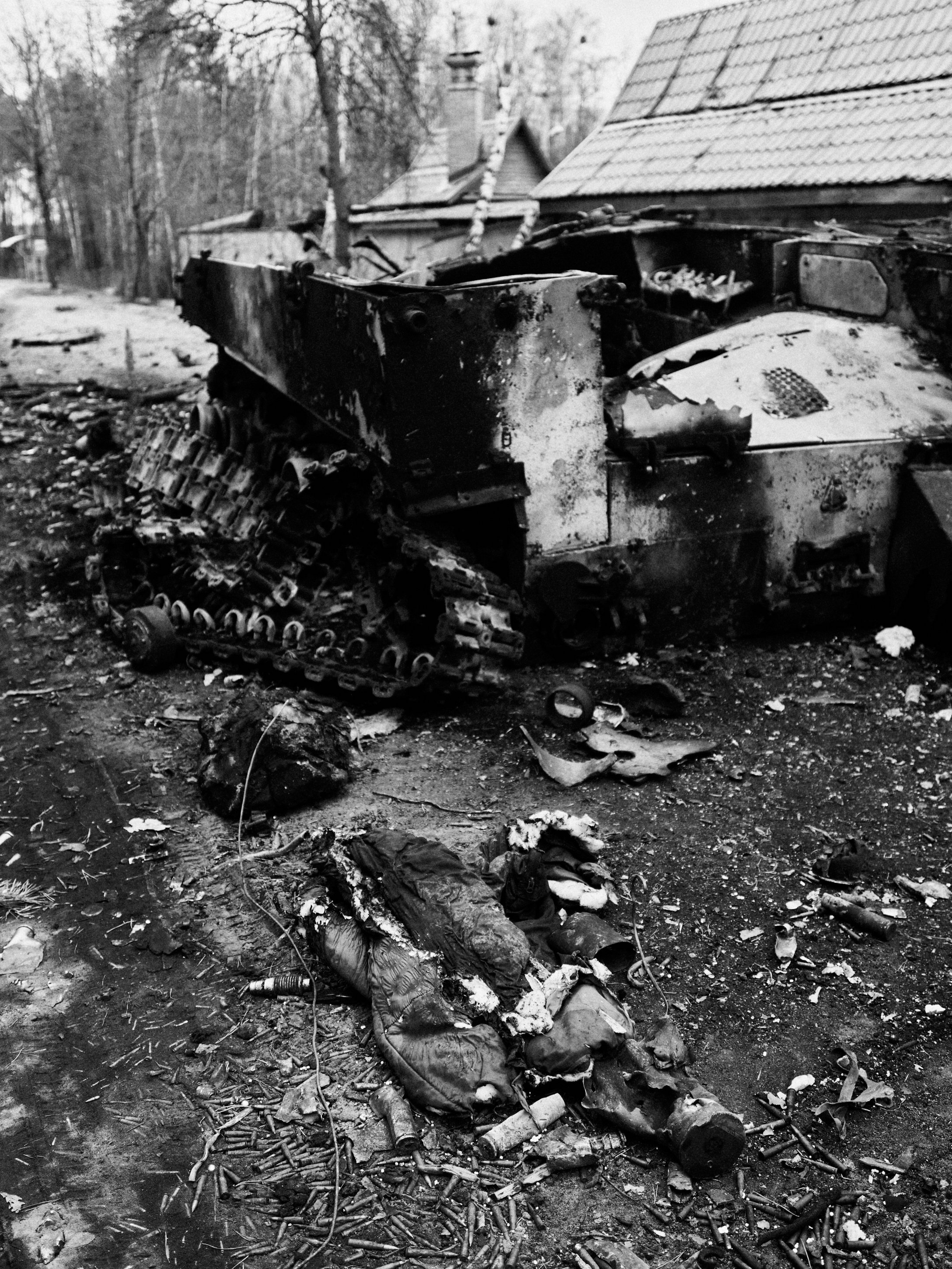 Remains of a Russian soldier and a burned vehicle in Irpin, Kyiv Oblast