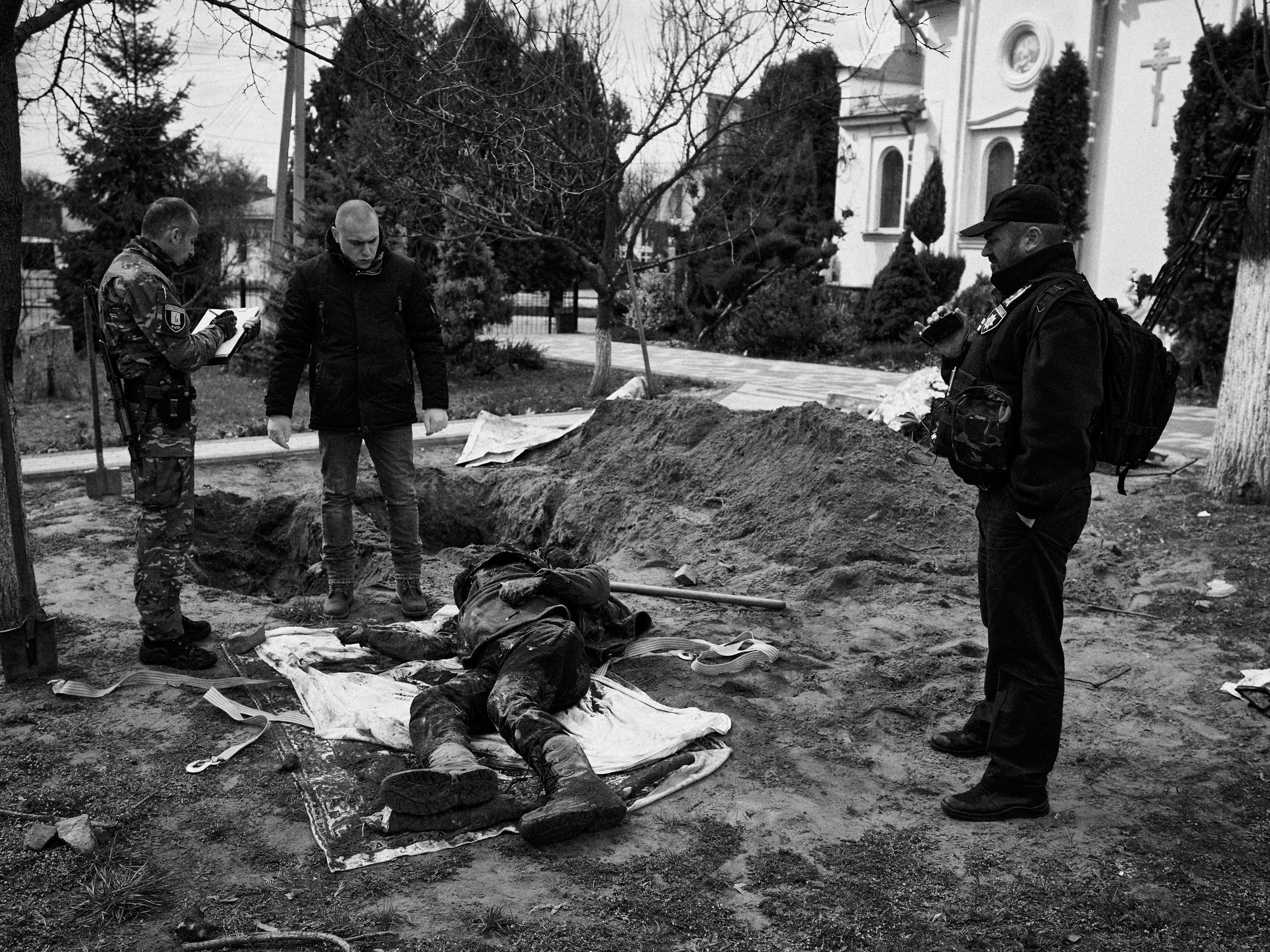 War crimes investigators exhume a body in Hostomel, Kyiv Oblast