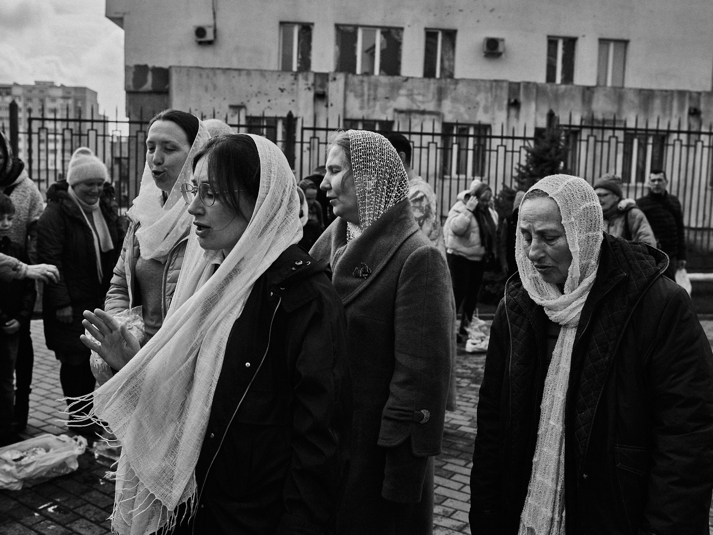 Women sing Easter songs outside of a damaged church, Kharkiv Oblast