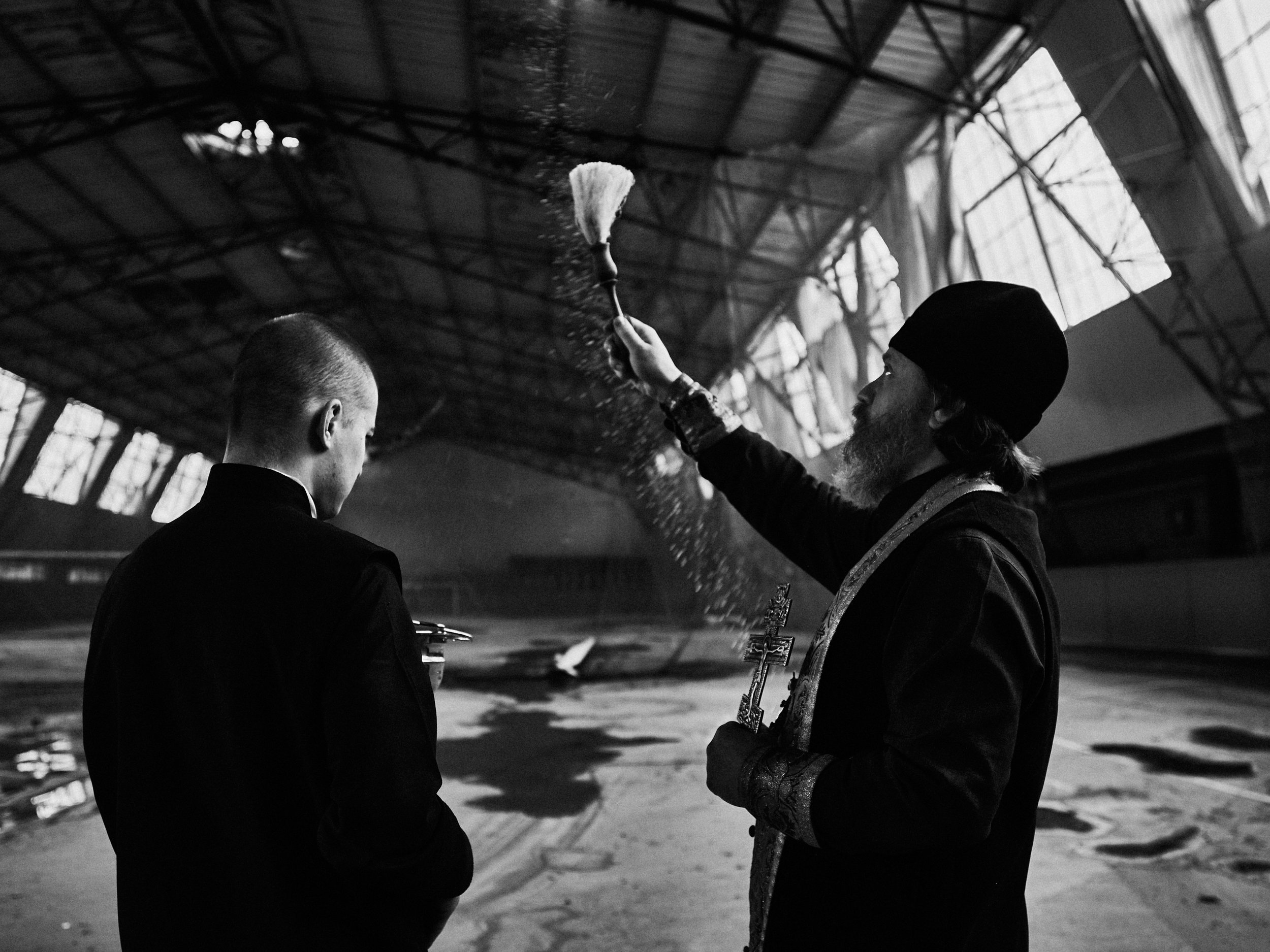 A priest blessing a destroyed warehouse on Easter, Kharkiv Oblast