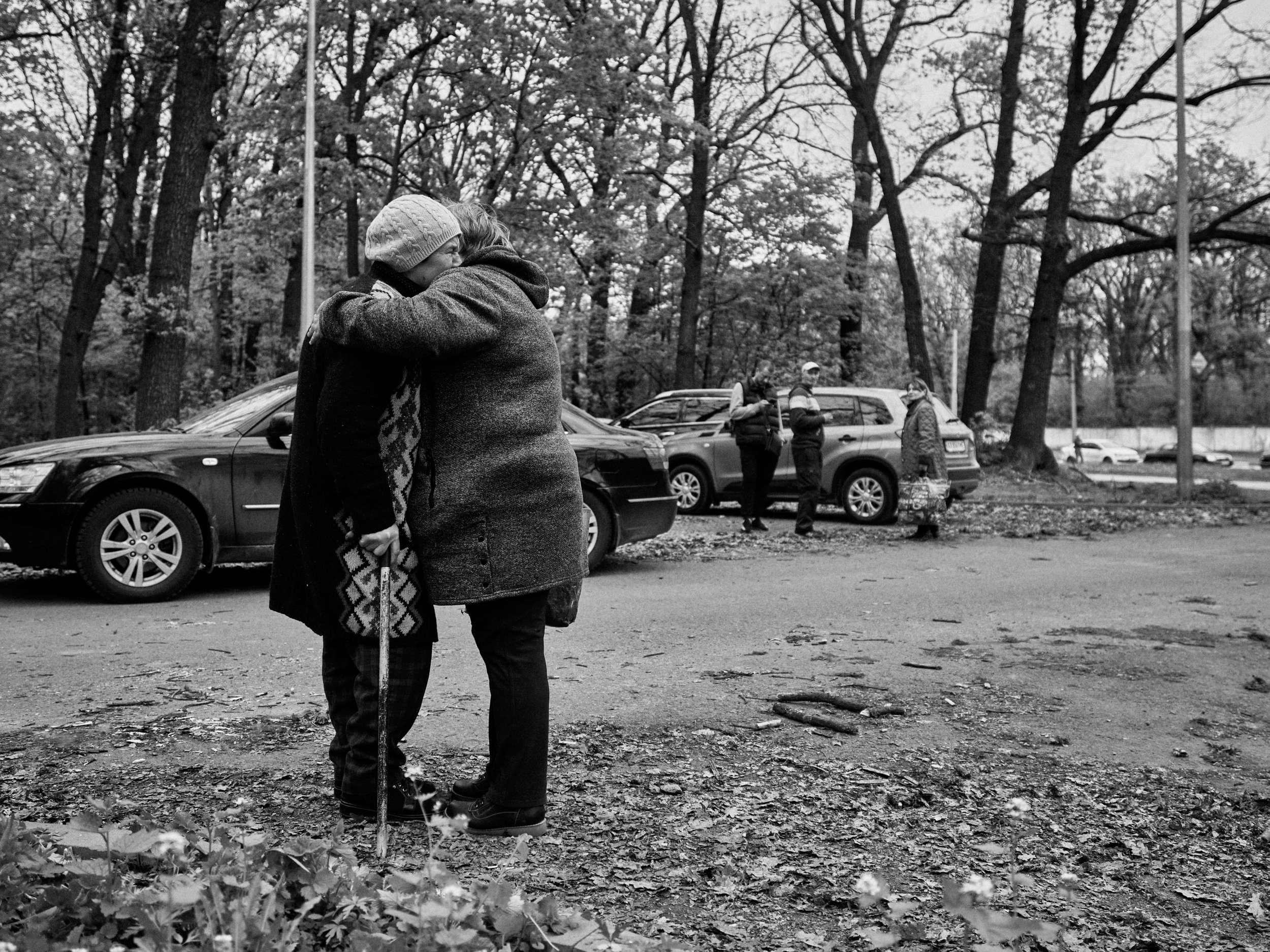 Two women embrace after fleeing liberated Ruska Lozova village, Kharkiv Oblast