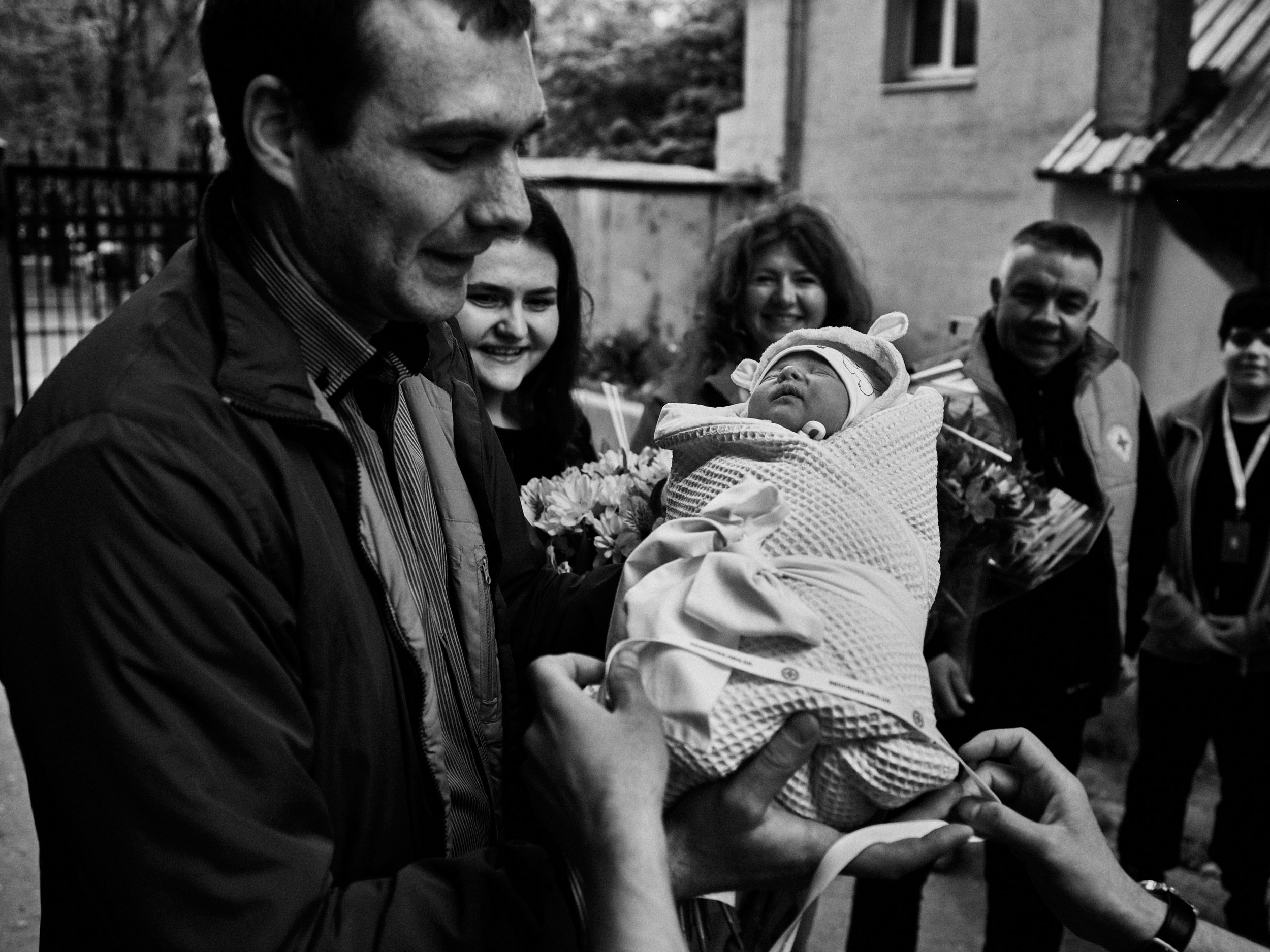 A newborn child is celebrated by Red Cross volunteers in Kharkiv, Kharkiv Oblast
