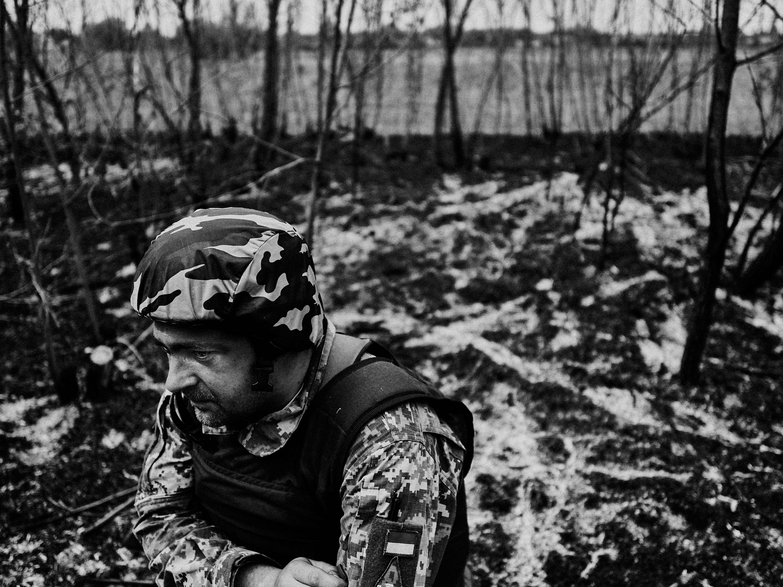 A territorial defense soldier resting in a forest hit with white phosphorous munitions, Zaporizhzhia Oblast