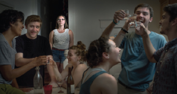Molly Smith (back) participates in a party scene re-enactment to tell her story of recovery.