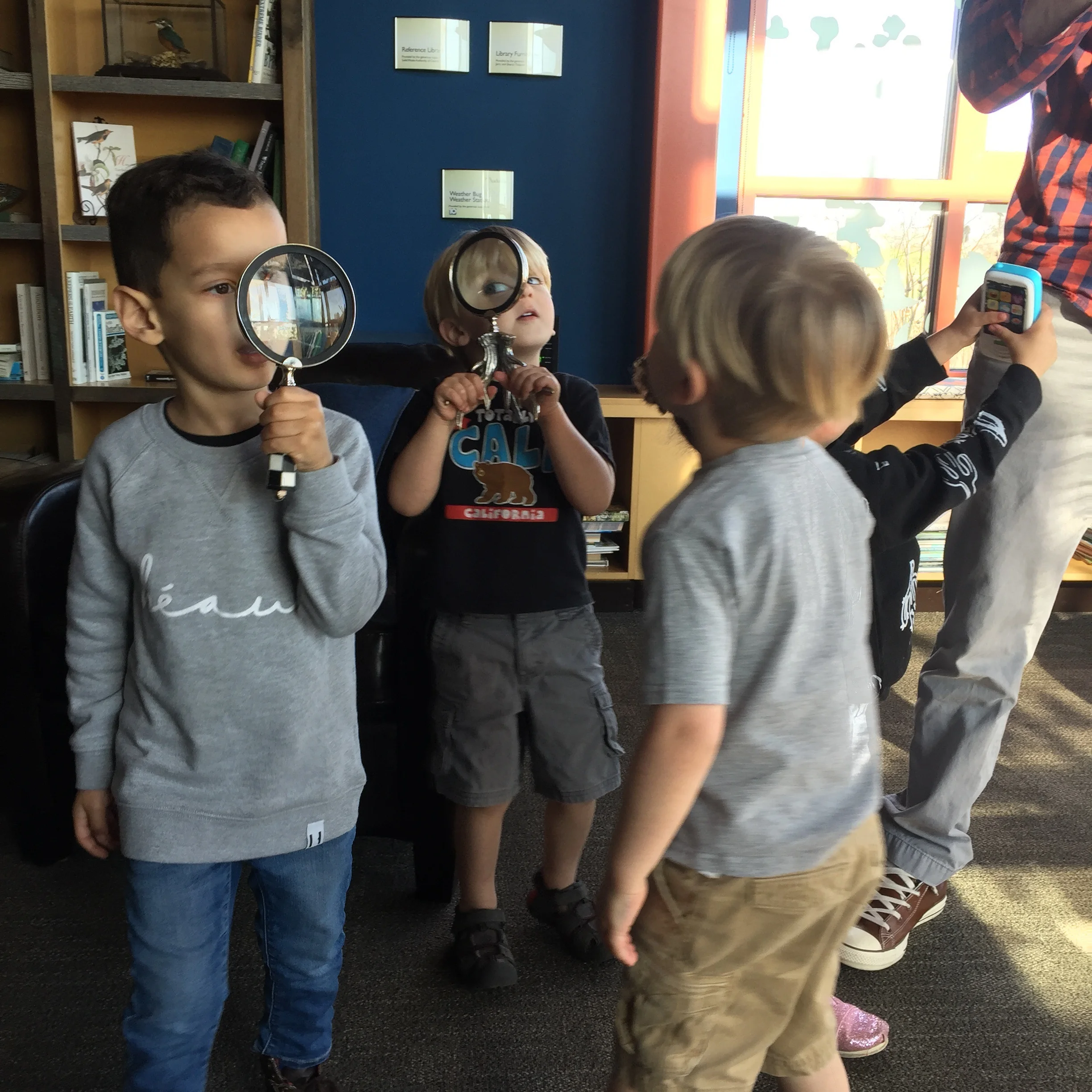 Adventure is everywhere! These kids are checking out the library before storytime begins.