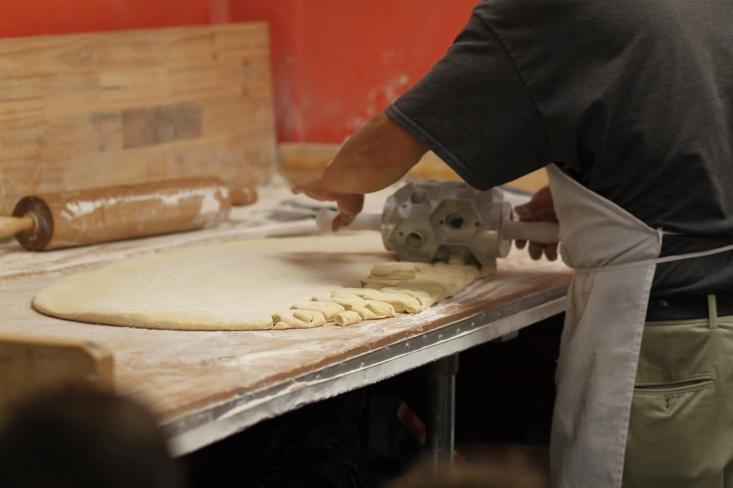 Then he uses this awesome device to cut out the doughnuts! 