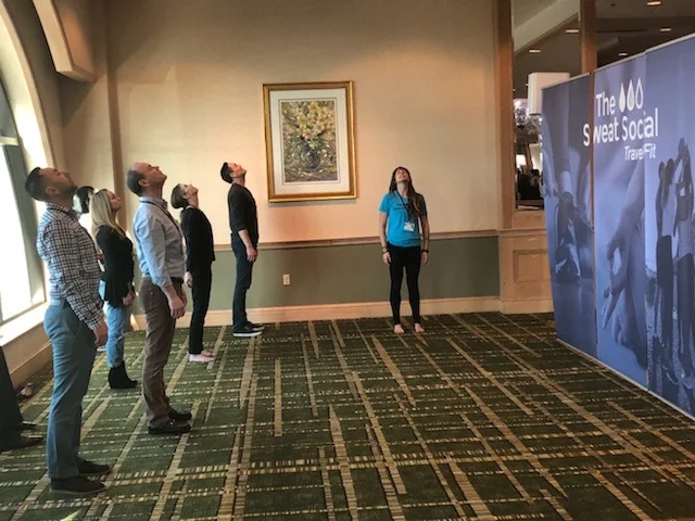 Meditation and stretching at a corporate conference.