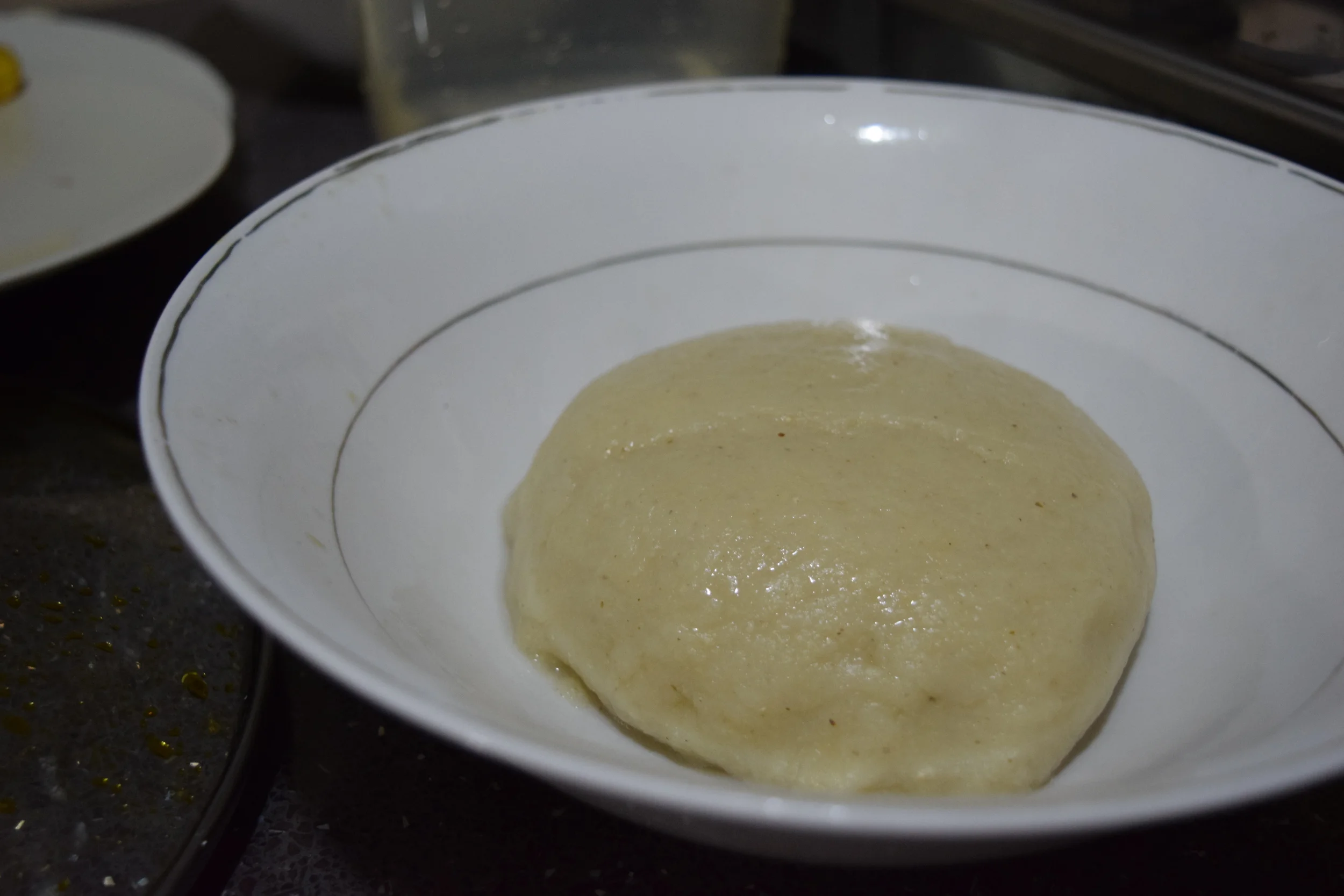 Freshly made banku, shapely by yours truly. Be careful not to eat too much or you will quickly find yourself fast asleep.