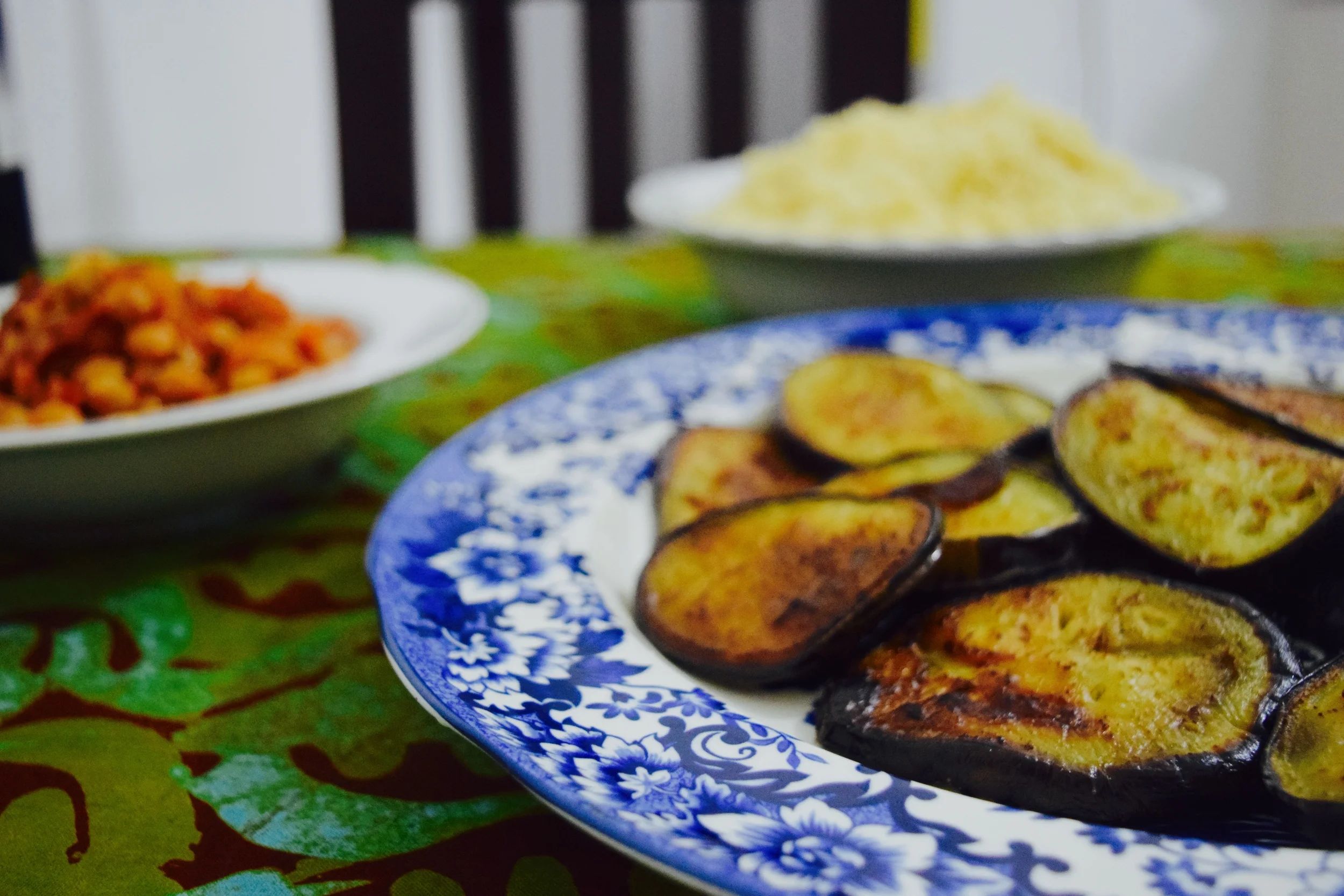 Fried eggplant accompanied by chickpeas in a tomato-onion berbere sauce