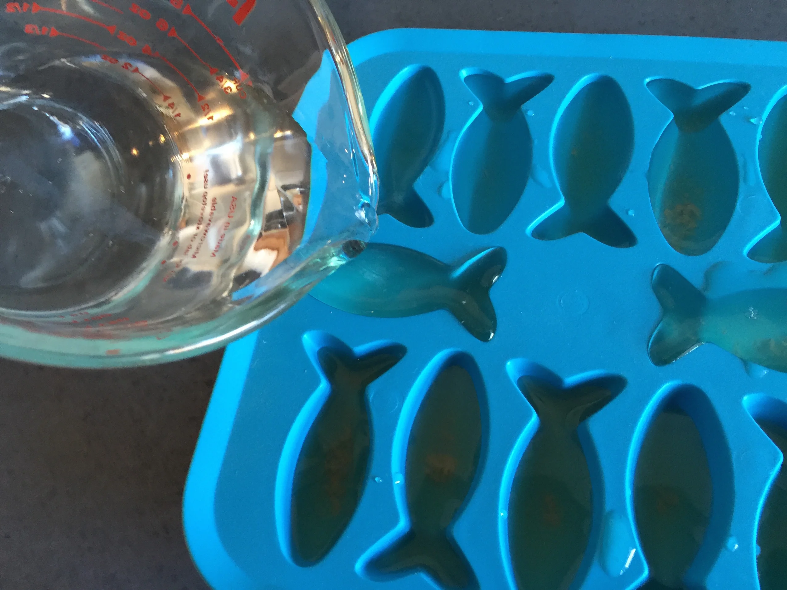 So first thing is to use the lid to squish alla the juice outta the fishies!! Squishing makes sure you get as much as you can!! Yes!! Then pour it into a cup or glass that is good at pouring so you don't make a mess!! You do NOT want to lose any of this 'mazing TUNAJUICE, amirite!!?? Yup!! ................