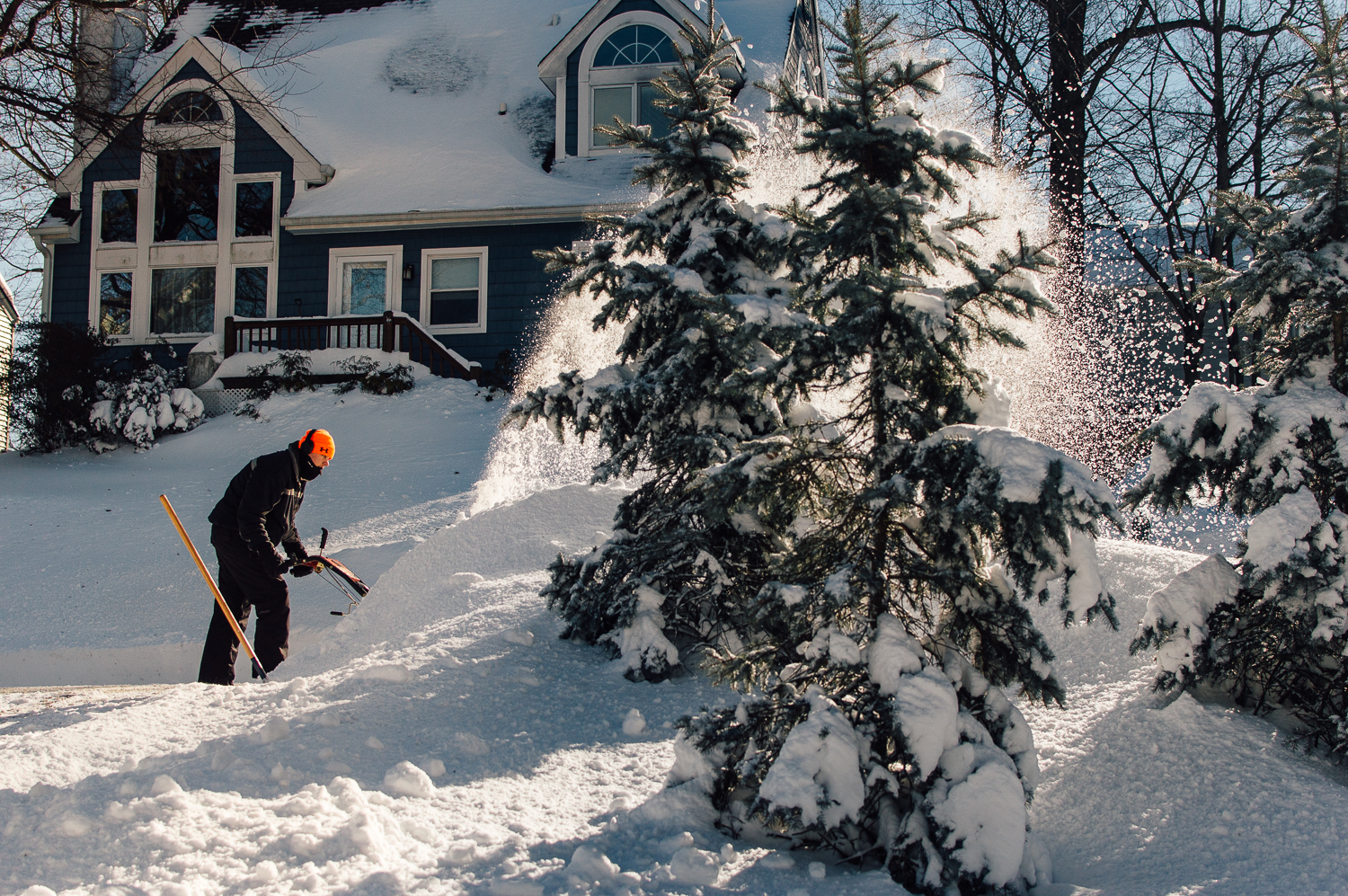 Aaron snow blowing the driveway and sidewalk