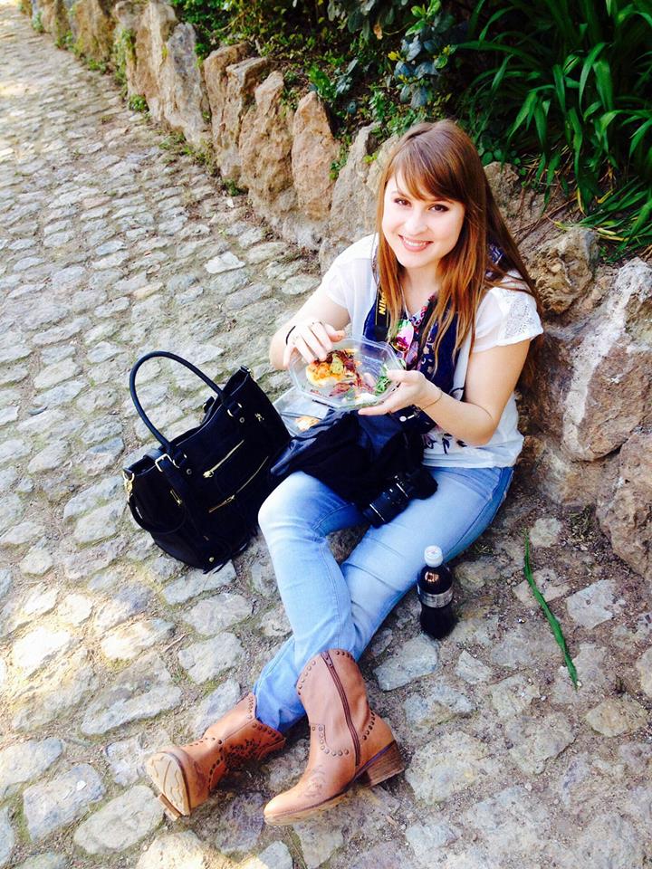This is me eating a cheap meal on the ground in Barcelona because it saved time and money. I often pack food in my purse to save money throughout the day.