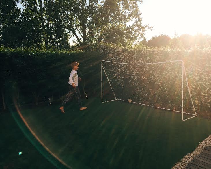 6.28 / 8:54 post meridiem // We had just finished dinner and Alvaro ran outside to play. I love this photo because you see the sunset and the beautiful honeysuckles behind the goal. 
