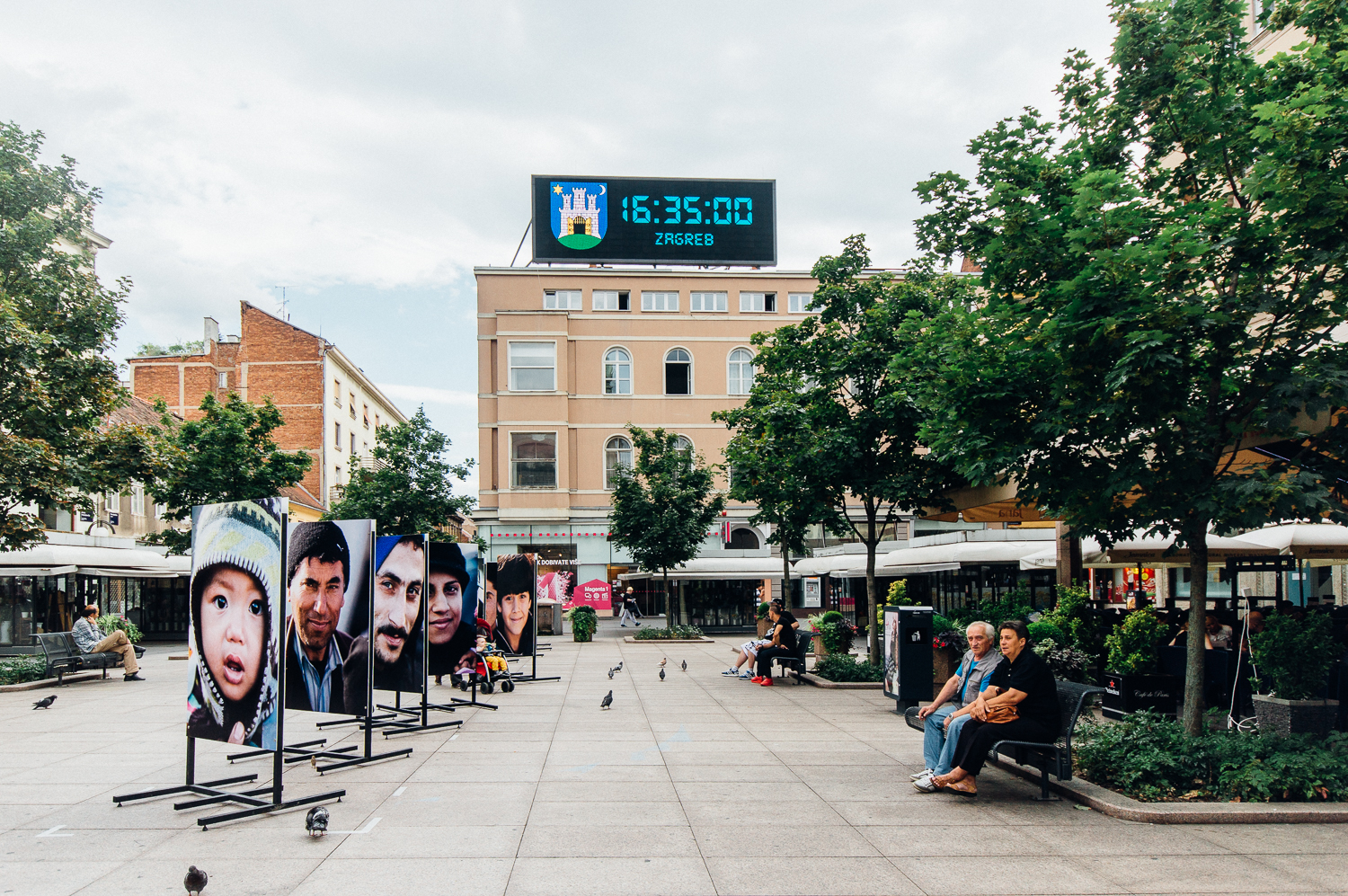 A common outdoor lounging area near the shops and restaurants displays a beautiful installation of refugees' portraits. In the comments below, I have typed the artist's statement of this installation if you're curious. Behind me in the photograph was another line of portraits and on the other side of the photographs you see are other portraits so this is only 1/4 of the entire installation.