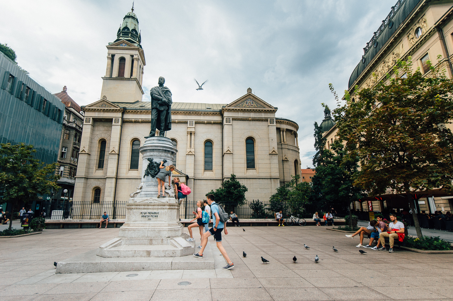 Children playing on and climbing a local statue. 