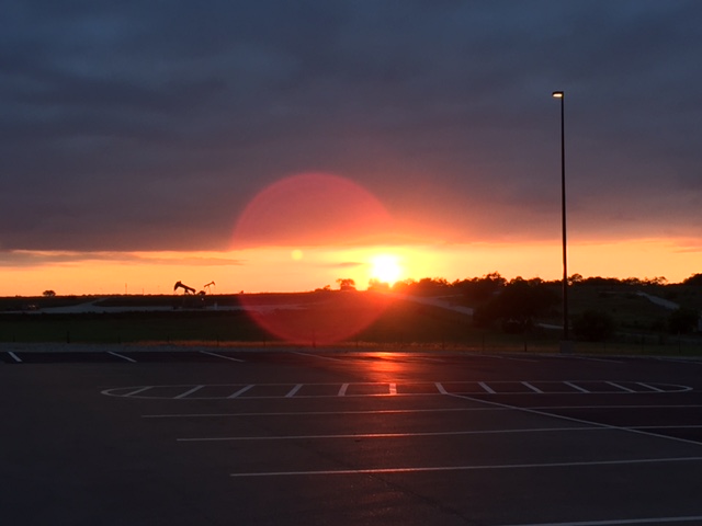Last week, I spent a couple of long evenings at the Karnes detention center in Karnes City, Texas. The sun sets late out here, and as soon as I walked outside, I snapped this view of the gorgeous sunset—one that the detainees inside sadly wouldn't be able to see.
