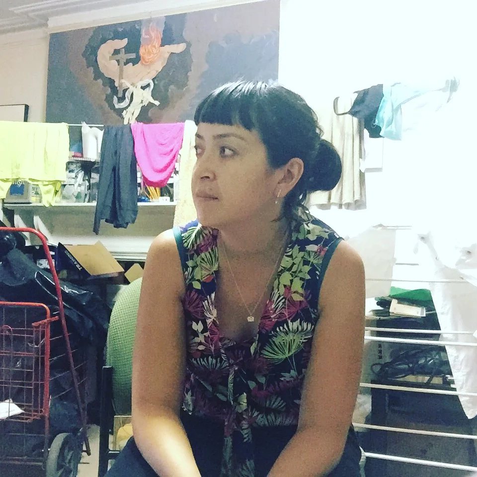 Earlier last week with another impromptu legal office: the sitting room of the house I'm living at in the South Bronx. A couple different women who live nearby came over to talk about their immigration claims. Here's to providing legal services from wherever -- clothes drying in the background and all.
