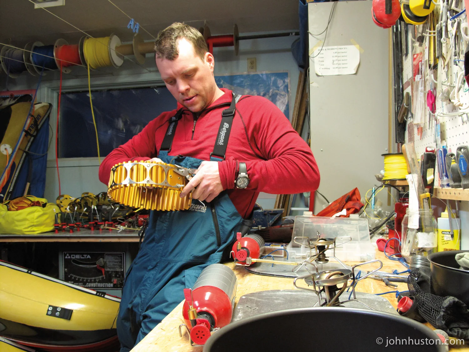 John, in Matty's workshop, putting together a heat exchanger, which increases stove efficiency.