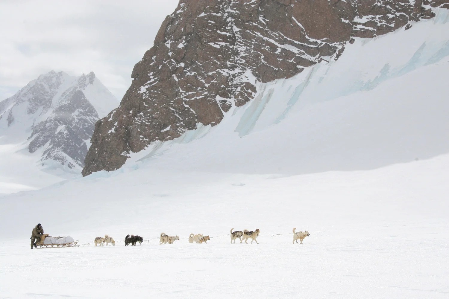 John Huston and his dog team head up a glacier in the Mount Forel range in southeast Greenland. The expedition restaged the Norwegian Roald Amundsen’s 1911 expedition to the South Pole and used all 1911-style food, clothing, and equipment. © Keo Films/BBC