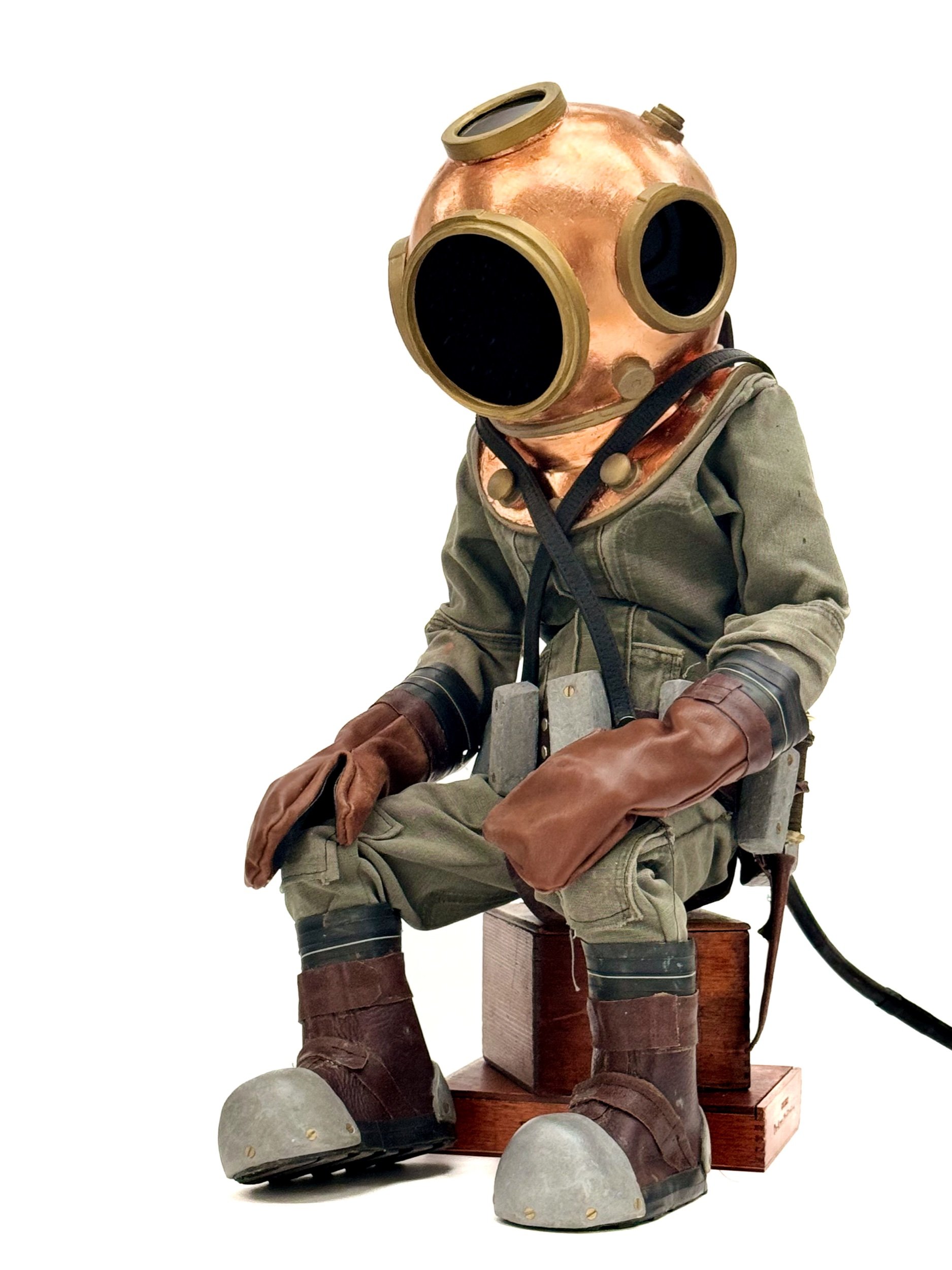 Diver (of Water detail) Used Carhartts, glove/boot leather, dog leash, belts, cigar boxes, bike tires, foam, epoxy, plexi, copper leaf, fasteners. Figure stands at 36” tall 2022