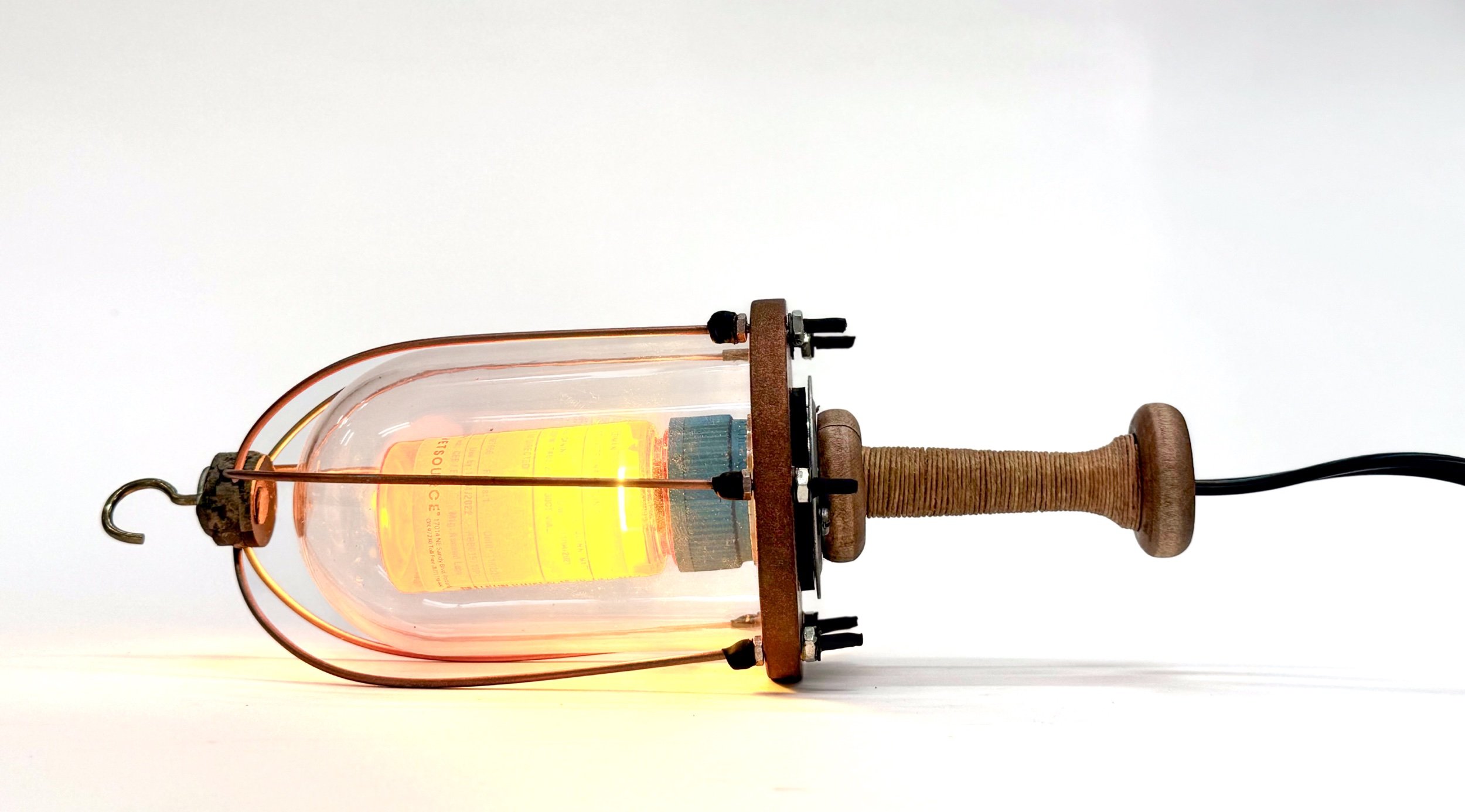 Lamp (of Water detail) Wood, braising rod, hemp cord, canine medication bottle, LED, plastic display case, fasteners, cord. 12”x4”diameter 2022