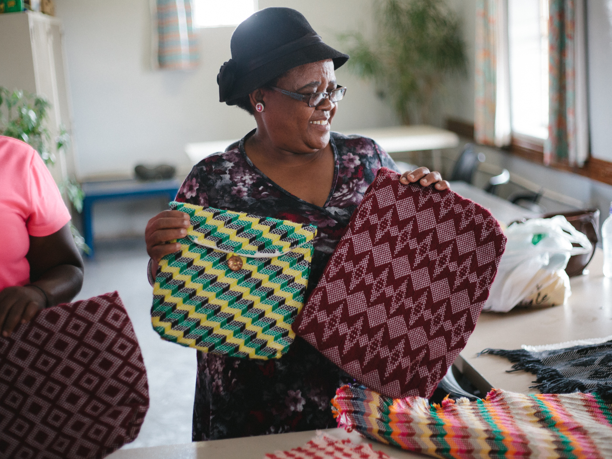 Women at Boitekong in Bloemfontein create beautiful purses out of thread and used plastic bags. They sell the bags to raise money for the center. 