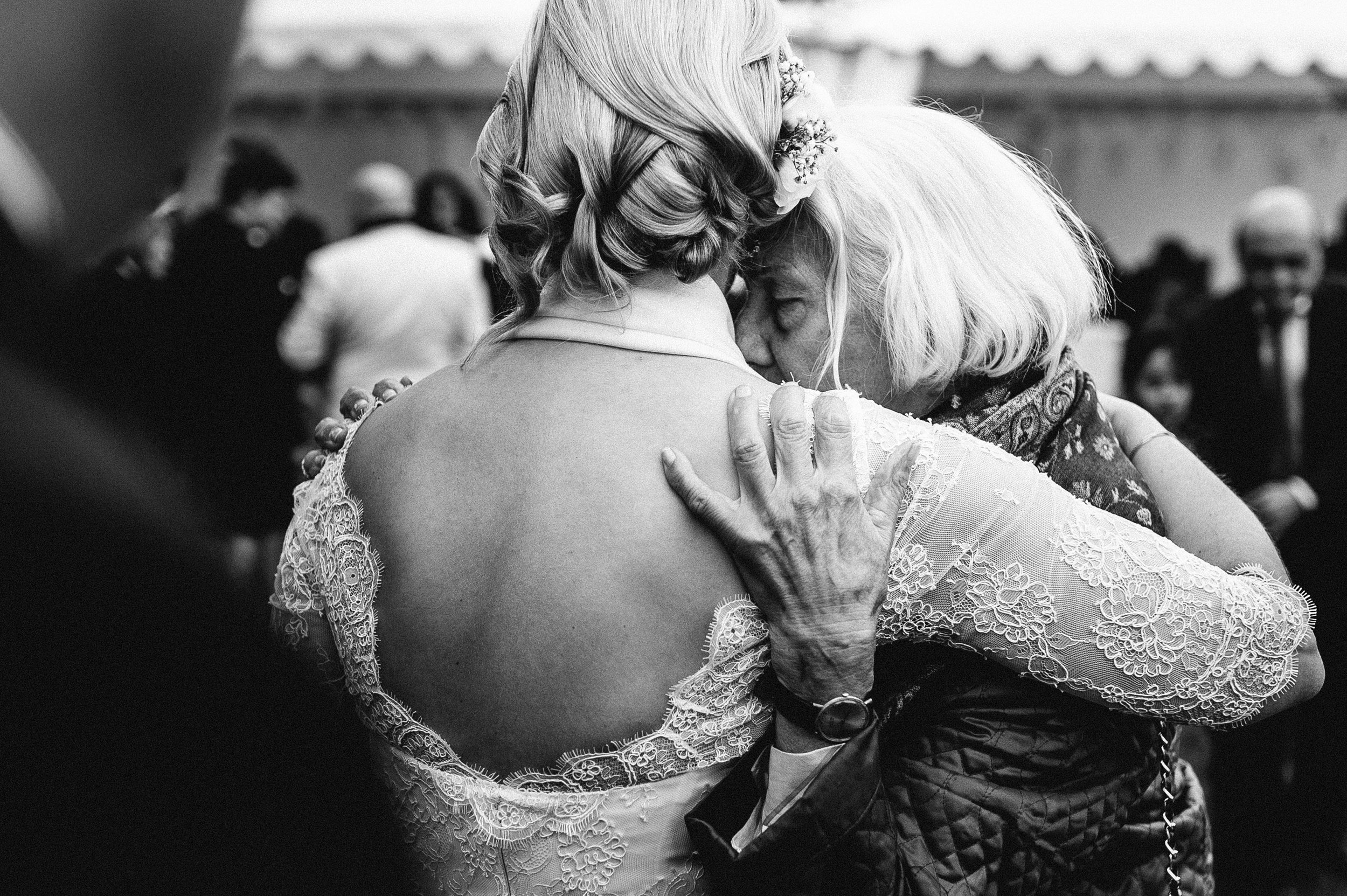  rührendes Hochzeitsbild einer Braut die ihre Grossmutter umarmt 