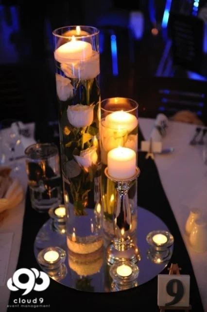 Table centrepiece . tulips + floating candles on mirror plate