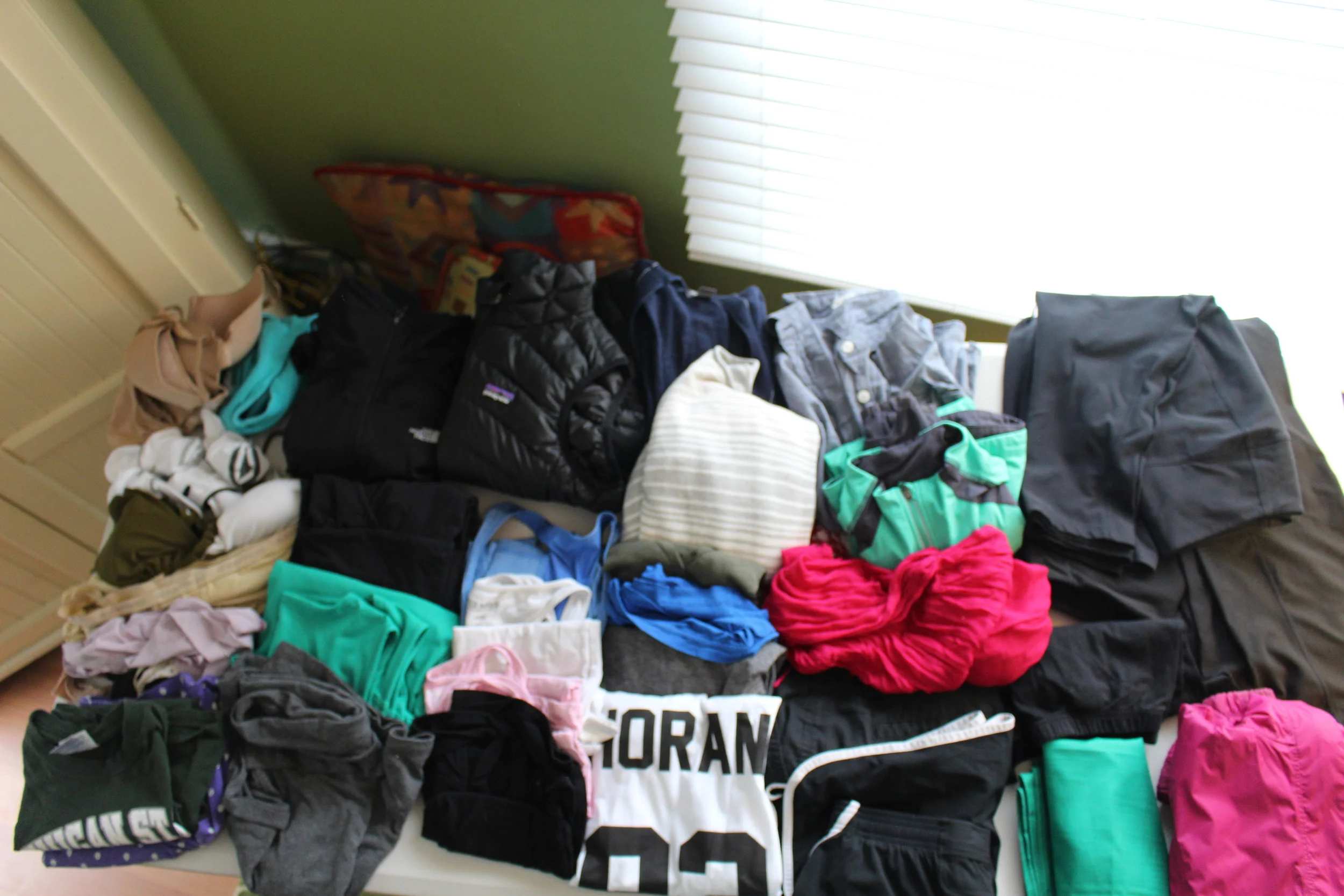 Necessities: Dresses/Skirts: Tops: Bottoms: 7 Pairs of Underwear Black 3/4 Sleeve Patagonia Dress 4 Tanks: Blue, White, Pink, Black Black JCrew Shorts 3 Bras Green Kavu "Eve" Dress 3 V-necks: Green, Blue, Grey Black Under Armour Shorts 4 Pairs of Socks Grey Old Navy Knee Length Skirt MSU t-shirt (PJs) Black Nike Cropped Leggings 1 Bathing Suit One Direction Shirt! Black Nike Cropped Pants Boxer Shorts (PJs) Black Long Sleeve North Face 1/4 Zip Black Eddie Bauer Active Pants Navy Long Sleeve Cardigan Black Eddie Bauer Active Leggings Striped Eddie Bauer Sweater Black Old Navy Leggings Denim Shirt Outerwear: Accessories: Shoes: (not pictured) Toiletries: Pink North Face Raincoat MSU Flag Black Nike Frees Shampoo/Conditioner/Body Wash Green/Grey LLBean Running Jacket Pink Scarf Grey/Black Merrell Sandals Toothpaste/Toothbrush/Mouthwash Black Patagonia Down Vest Pepper Spray Cheap Black Flats Deodorant Knife Quick Dry Towel/Wash Cloth Metal Spork Umbrella Selfie Stick (it was a gift!) Detergent/Clothes Line Power Strip