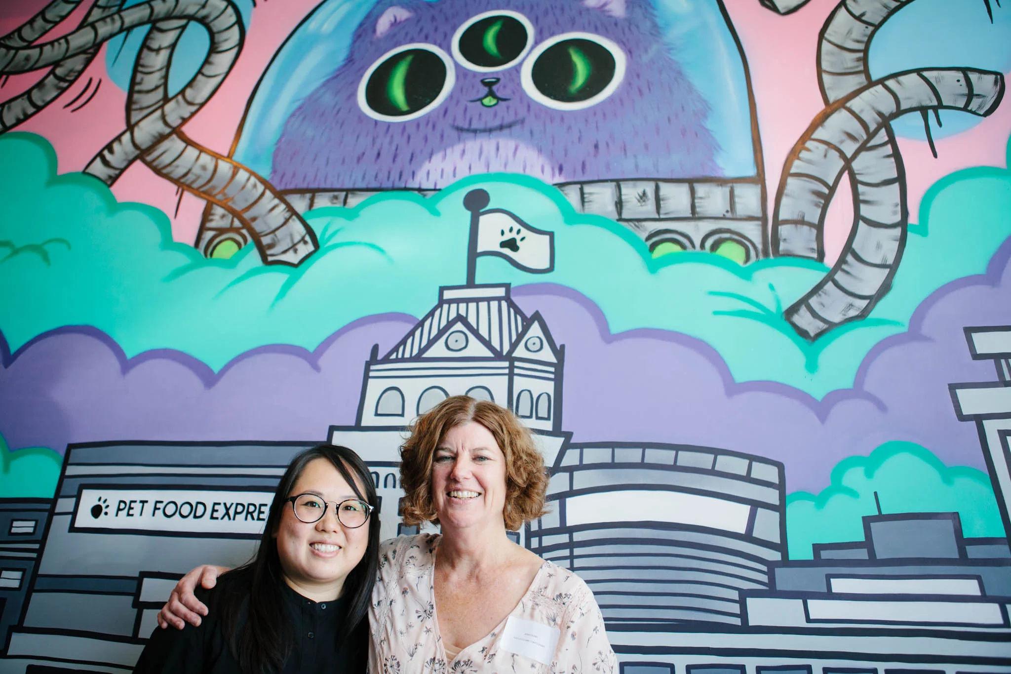 Michelle (left) and Ann pose at our mural reveal party on April 7th. Photo by Scott Russell.