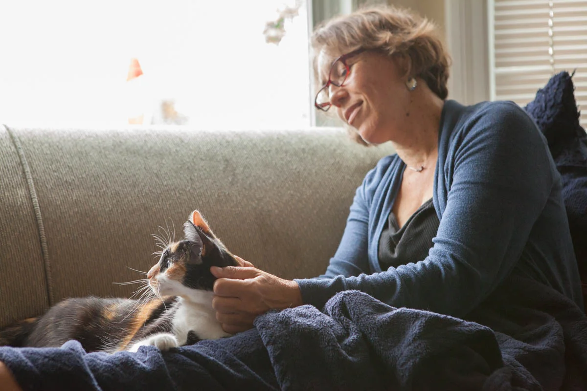 Jules cuddling on the couch with her adopter, Sabine. At first Jules wouldn’t allow anyone to touch her, but Sabine always knew there was hope.