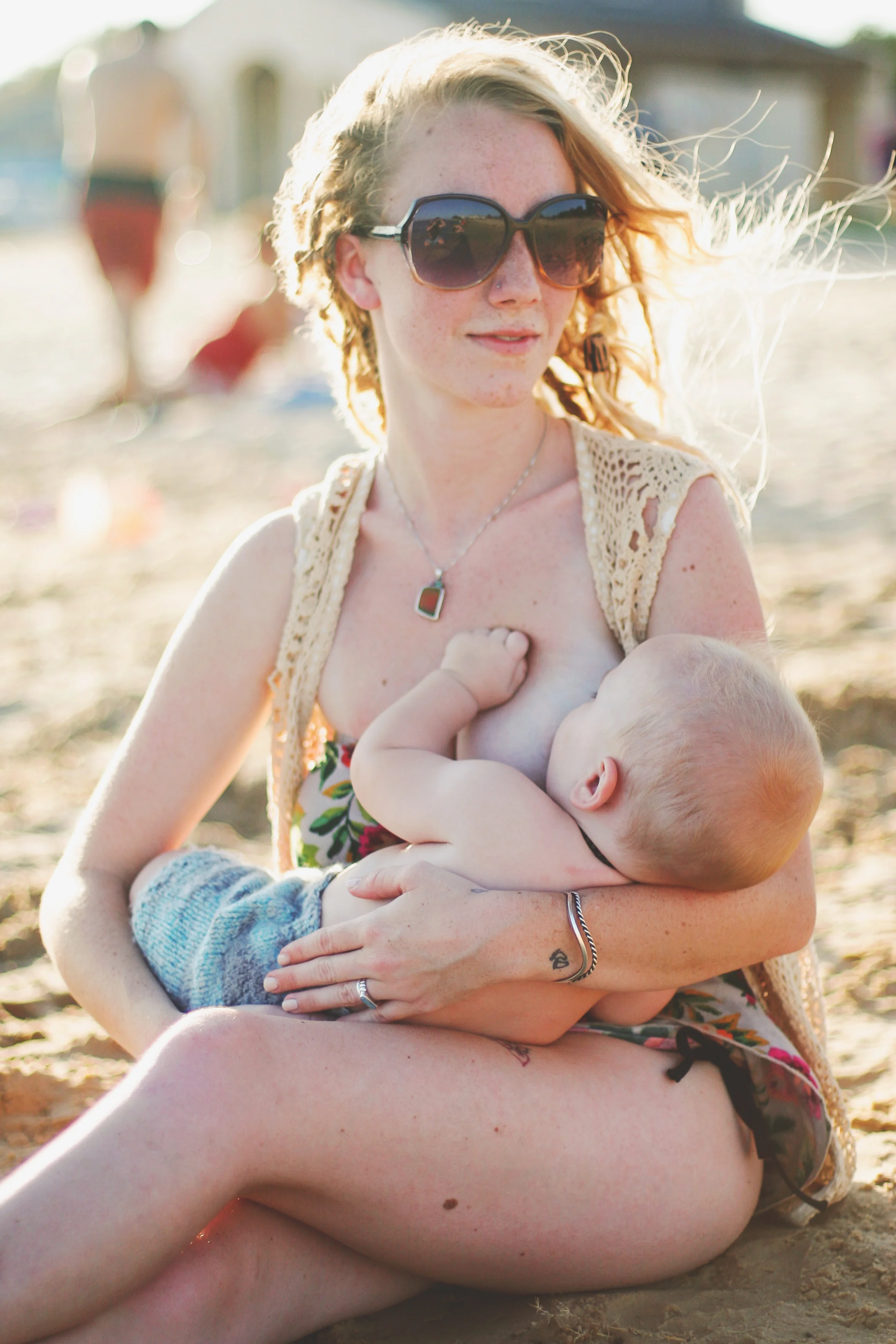  Mother nursing her son on public beach in beautiful light by South Texas Award Winning Maternity, Baby, and Family Photographer, Mae Burke- Photographing families in and visiting Rockport, Port Aransas, Corpus Christi, Austin, Houston and Fort Worth