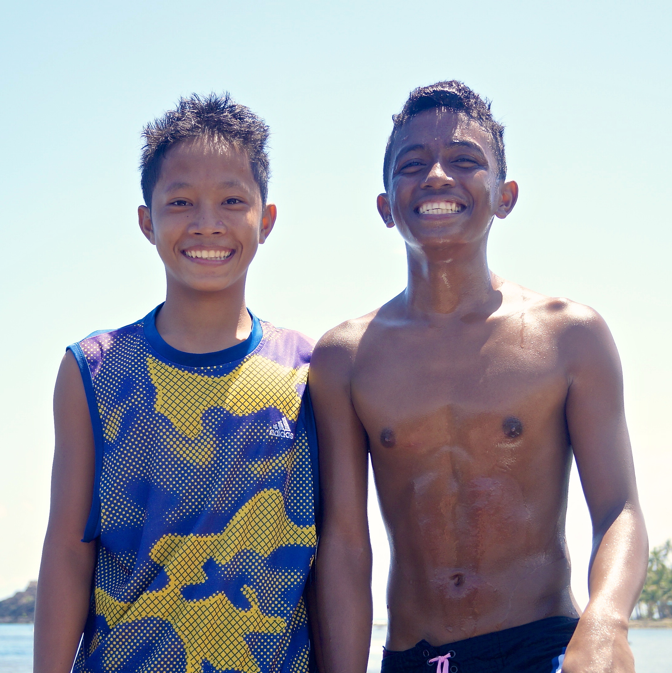 Two cute local teens (still smiling, even though their boards got ripped in half. Oops!)