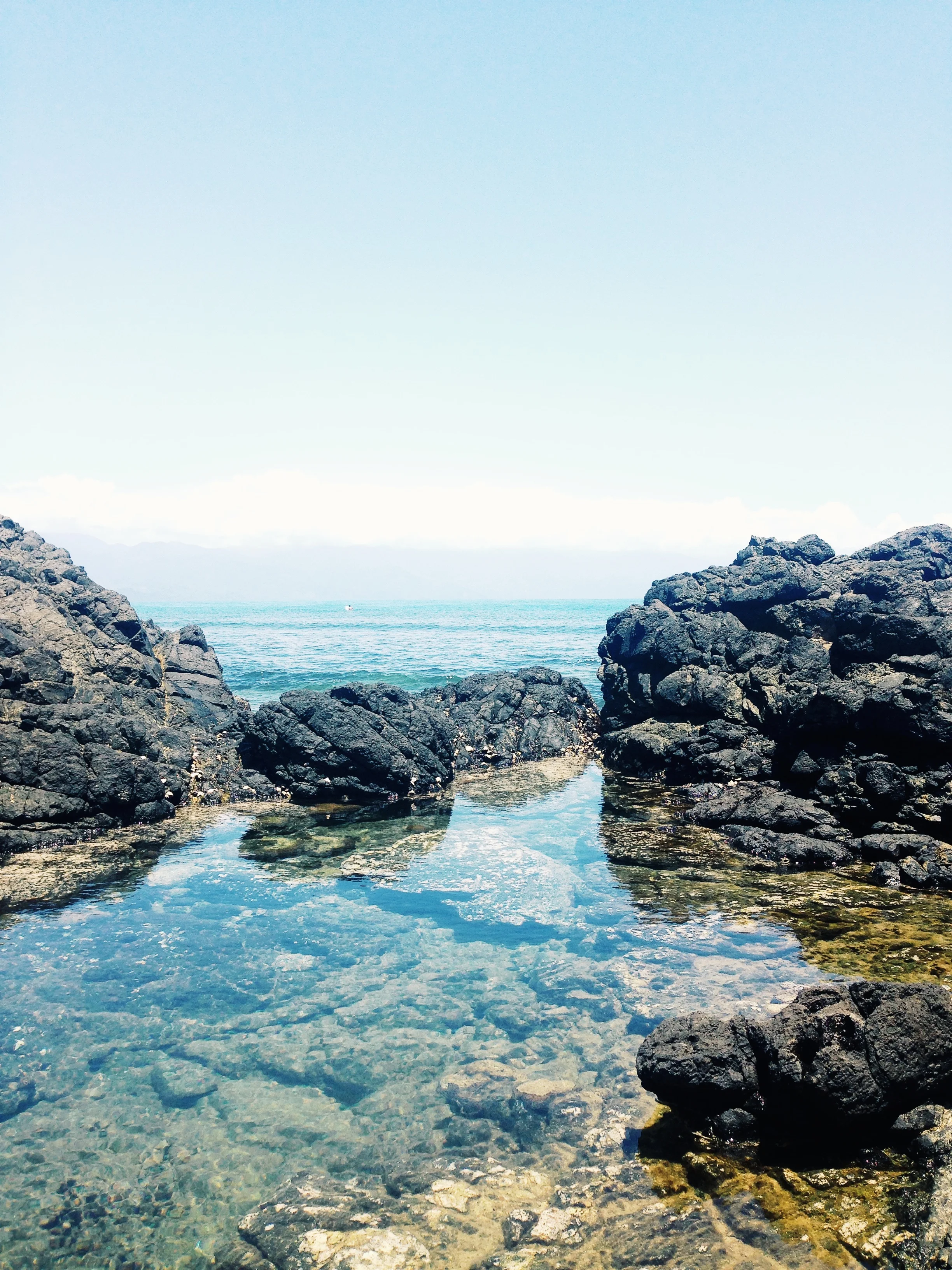 Crystal clear rock pools at Cemento Reef