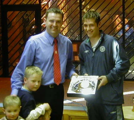 Celtic's captain presents Bruce with a silver salver.