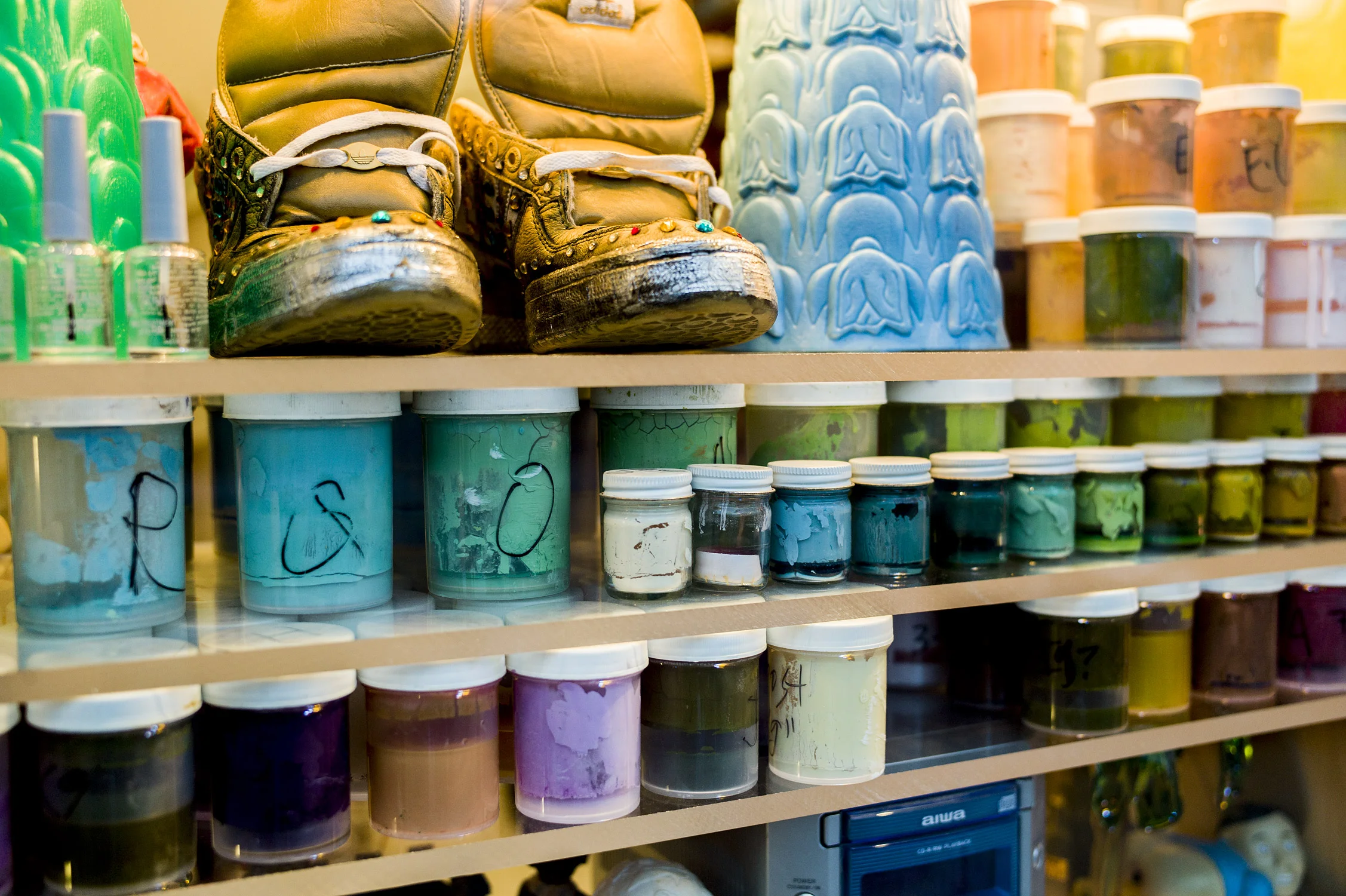 Detail of Ricci Albenda's paint-mixing containers, Adidas sneakers by Rosalie Knox