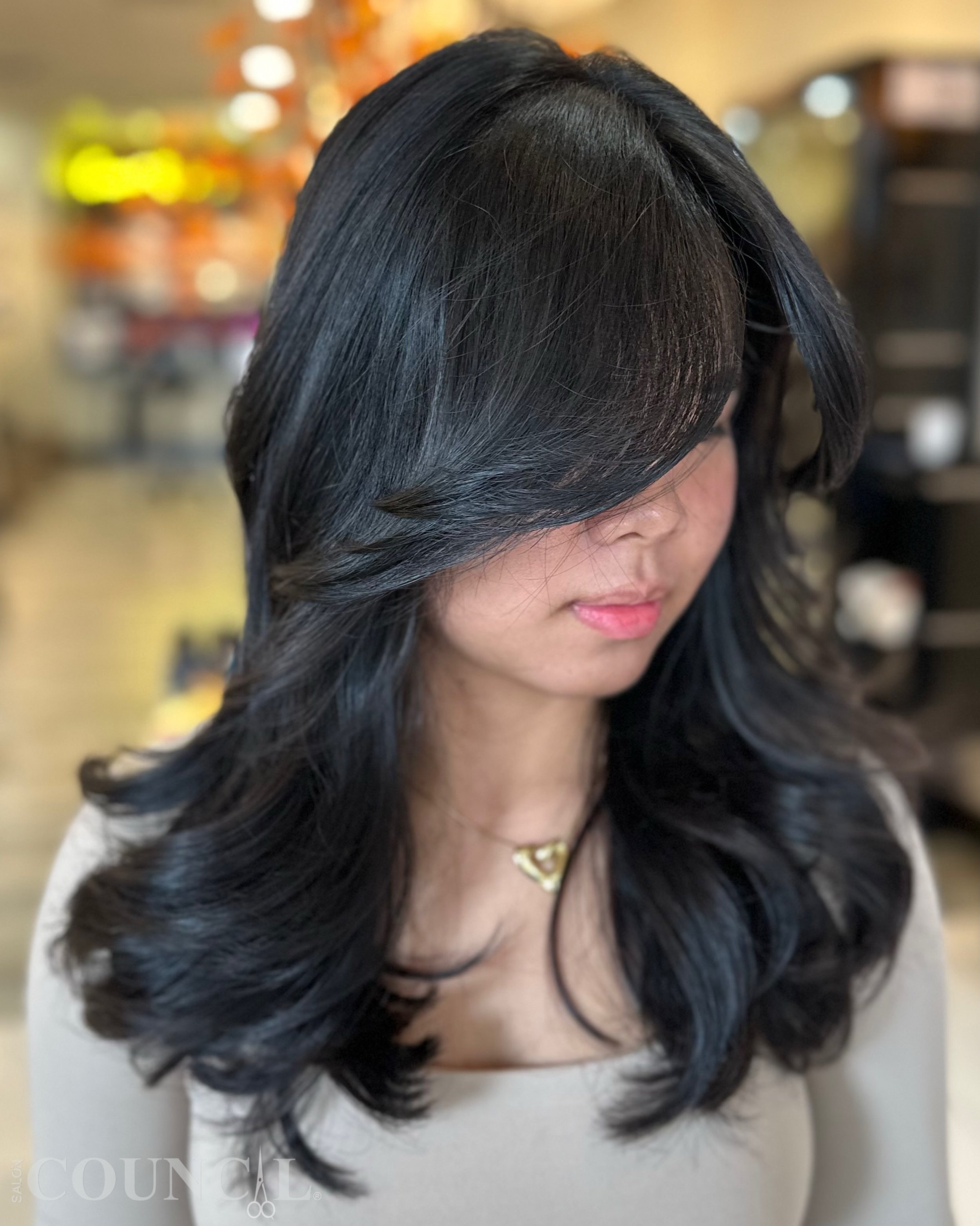 Sleek, shiny, and effortlessly beautiful. 🖤

A chic long bob with soft layers, face-framing, and curtain bangs&mdash;perfectly complementing this gorgeous natural black hair.

Beautiful hair, only at Salon Council. 🤍

#SalonCouncil #LongBob #Curtai