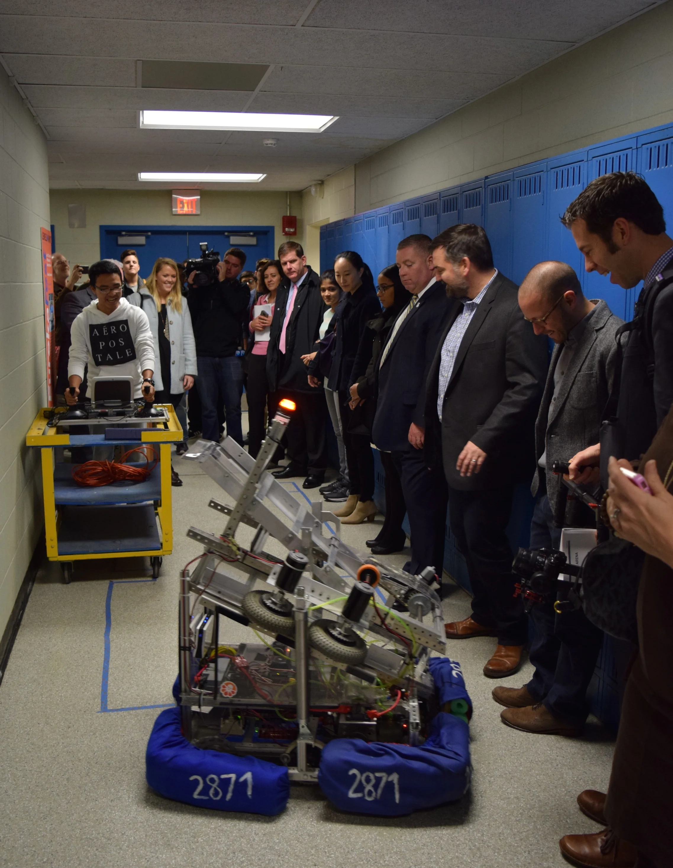 Mayor Marty Walsh viewing the solar-powered cleaner, also known as Fred, operated by a member of the building team. 