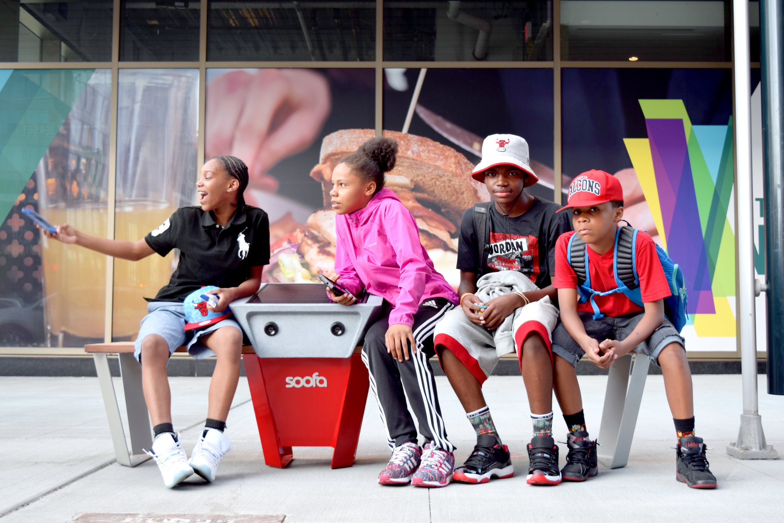 Kids gather on Soofa Bench