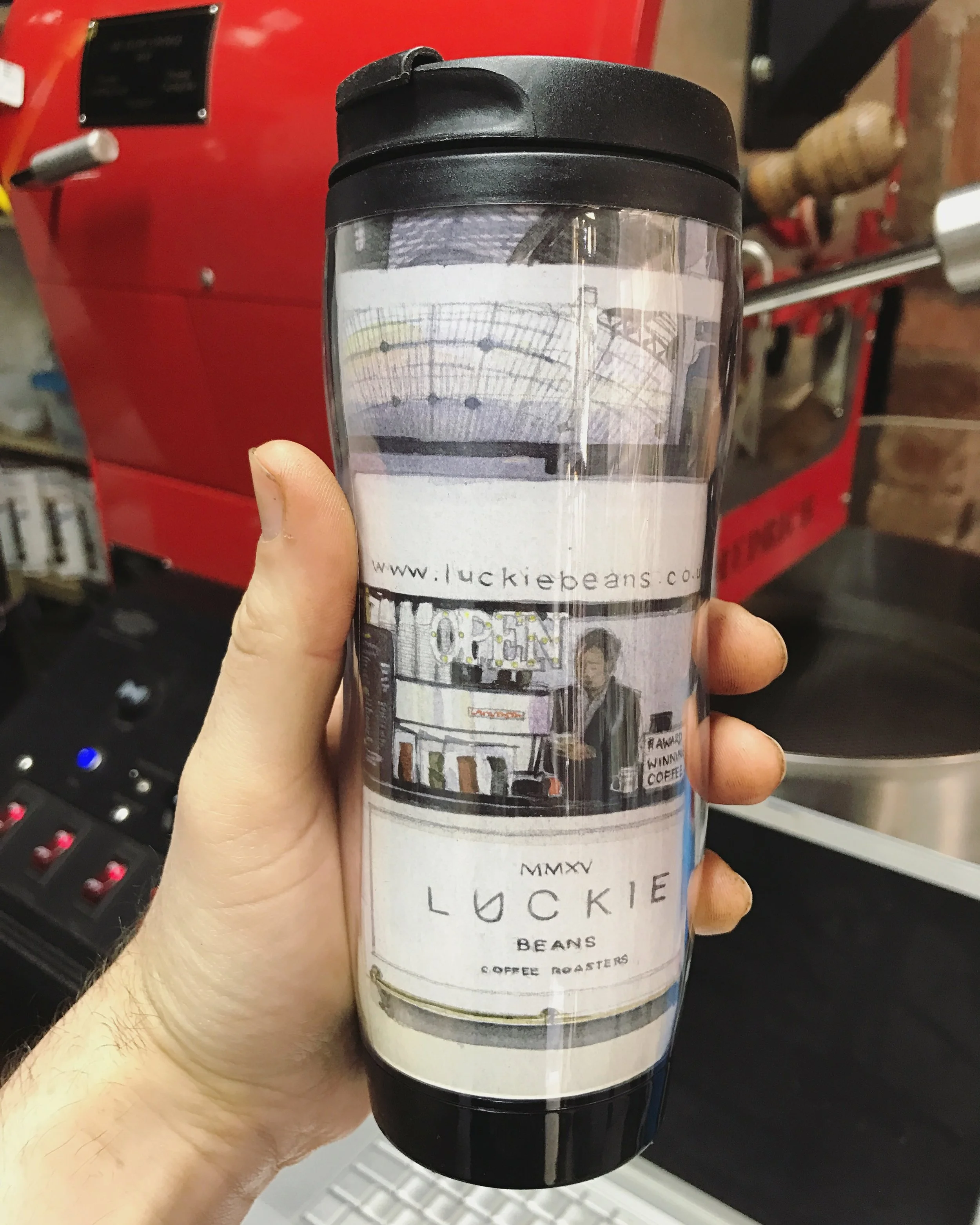 Luckie Beans Wil Freeborn travel cup in roastery.JPG