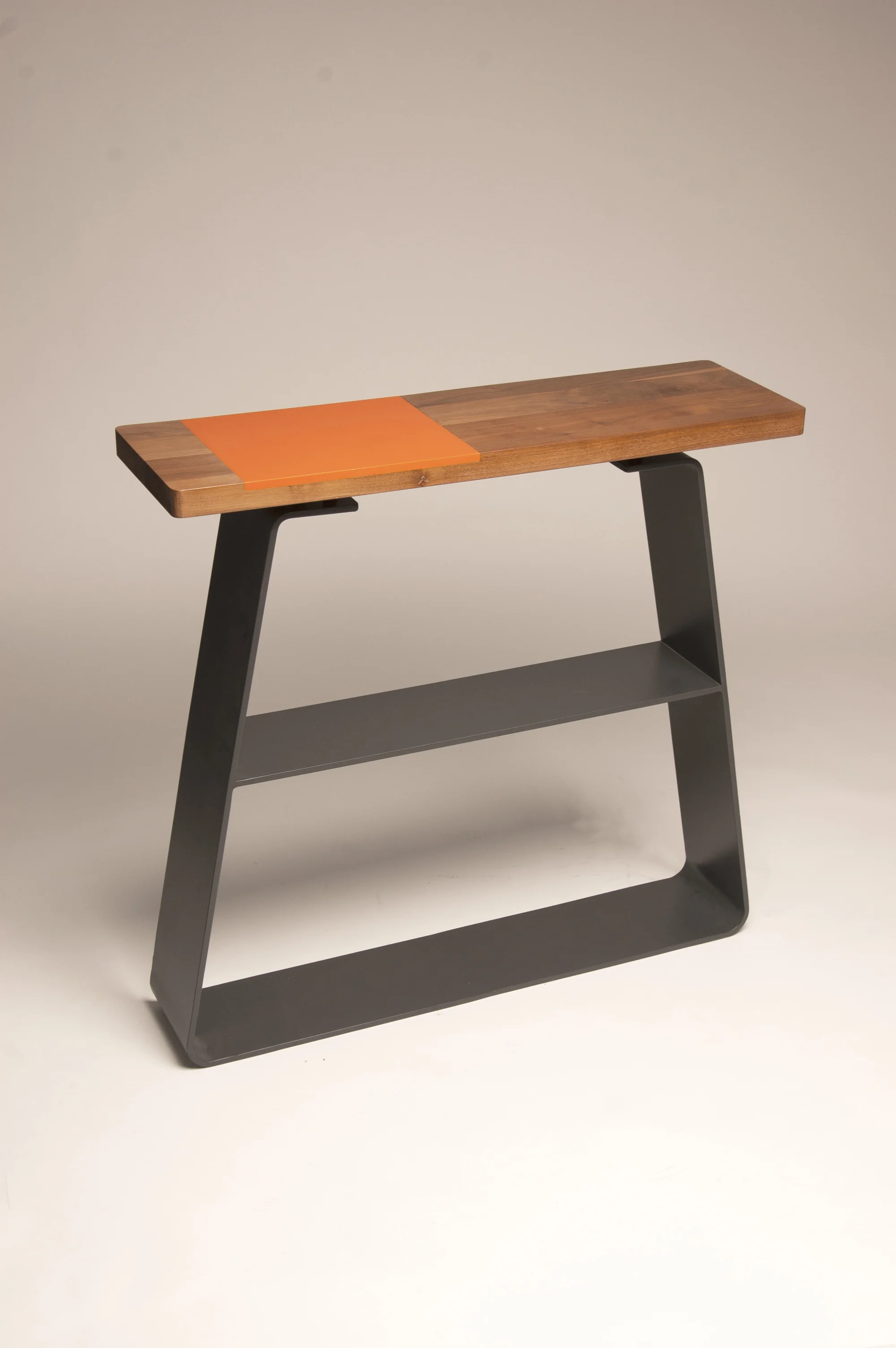 Låda Console Table The låda range is inspired by pre rolled stock such as box section. The use of mix materials creates a conversation due to the contrast it creates in colour and texture. The simple clean geometric shapes allow for the materials to be the most important part of this range. The console table is perfect for displaying items and adding a touch of contemporary aesthetic to the home.