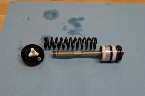This is the cartridge pressurization system. It uses a spring and floating piston like the WP Cone Valve and many KYB and Showa forks.
