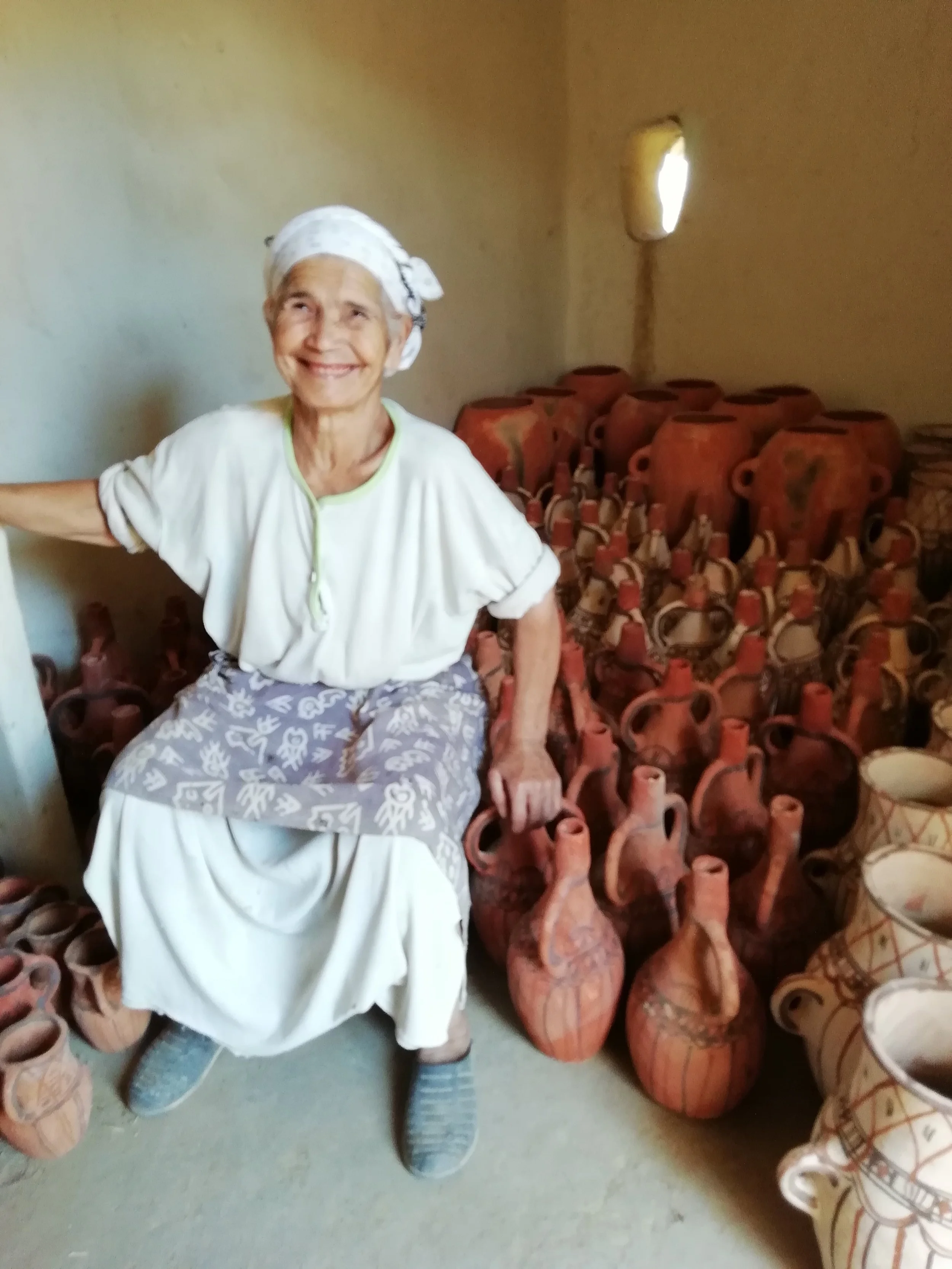 My new idol - Mama Aicha sat on a barn full of her beautiful ceramics - Ready to be exported by the Sumano Organisation.