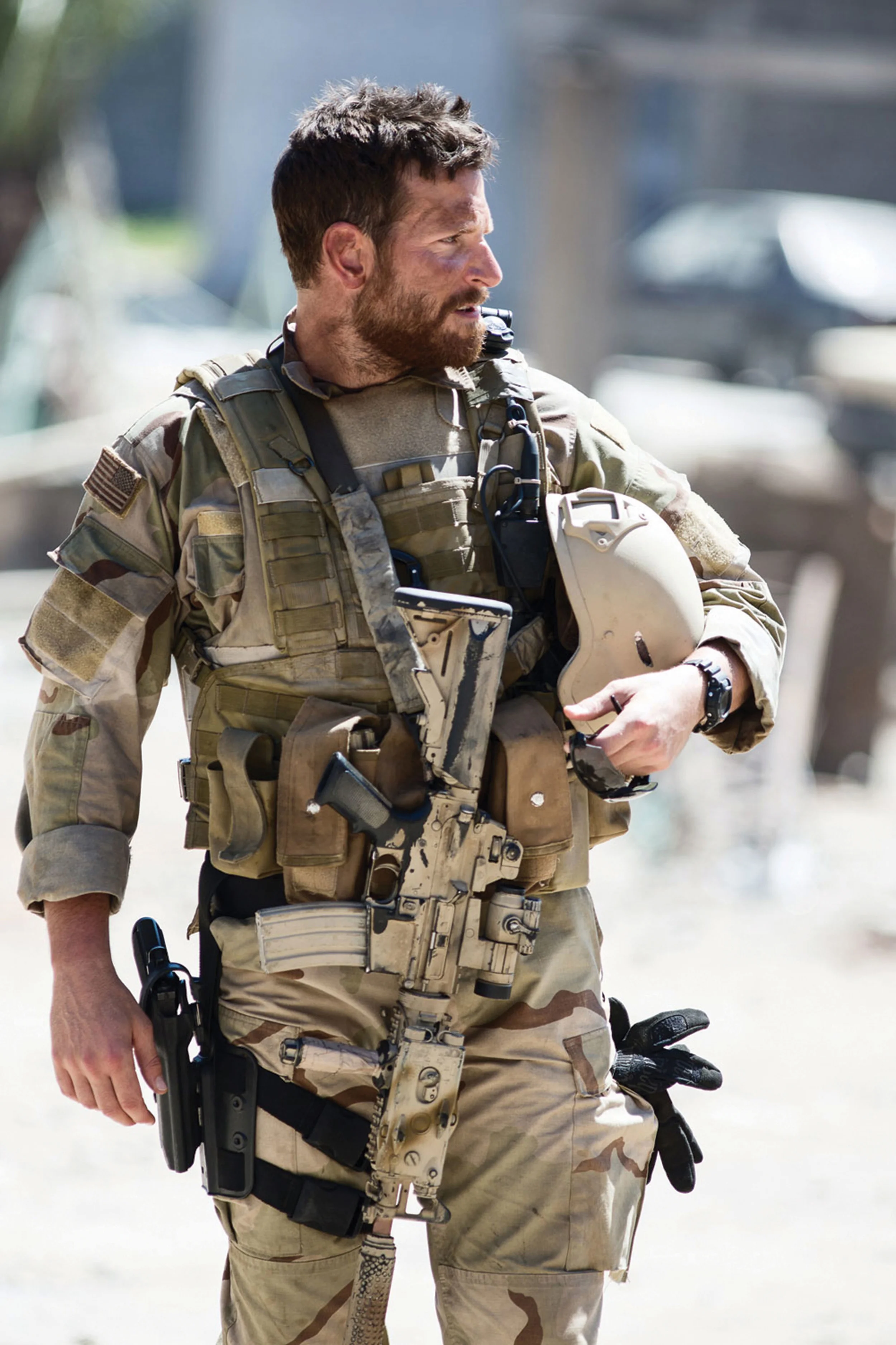 A beefed up Bradley Cooper as Chris Kyle, America’s deadliest sniper, in Clint Eastwood’s blockbuster homage to the warrior ethos, American Sniper (2014).