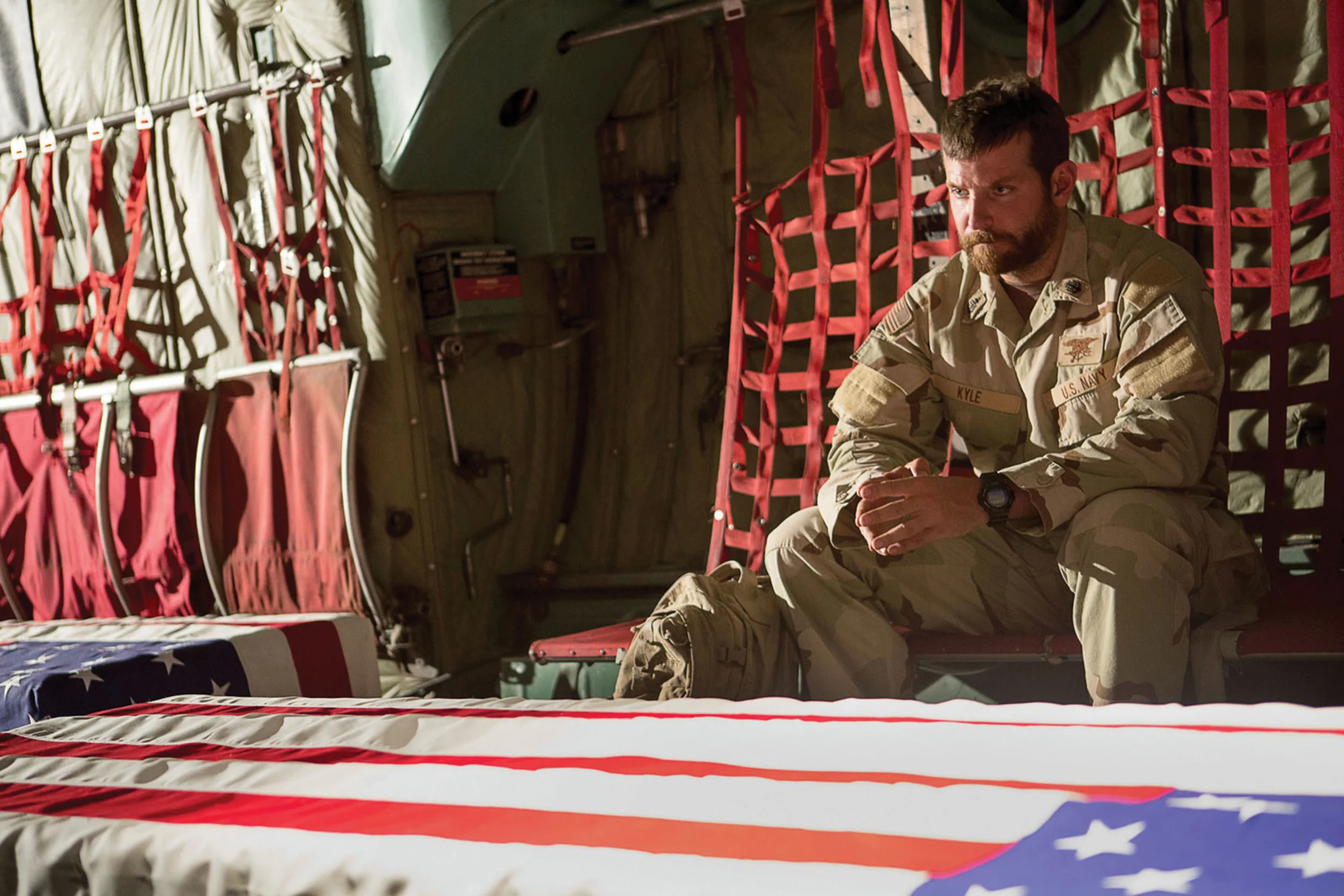 Chris Kyle (Bradley Cooper) returning home with two of the 4,491 Americans killed during the Iraq war.