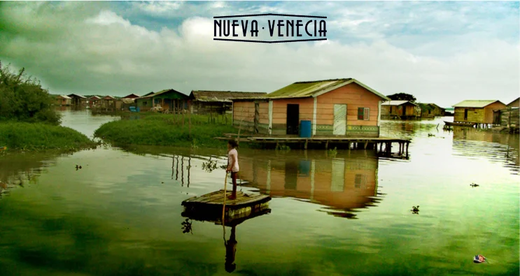 The houses in this fishing village on Colombia's Caribbean Coast perch atop piles in Nueva Venecia .