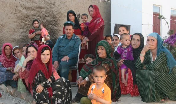 Women and their children gather in No Burqas Behind Bars with the prison guard who is, in some ways, a friend