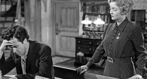 Coalminer Morgan Evans is schooled by Miss Moffatt (John Dall and Bette Davis )